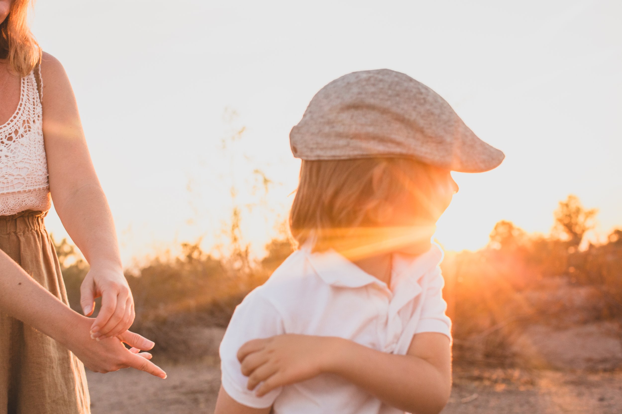 Mother and son playing together during family desert photo session near Papago Park in Tempe, Arizona by Phoenix based family photographer Jennifer Lind Schutsky. 