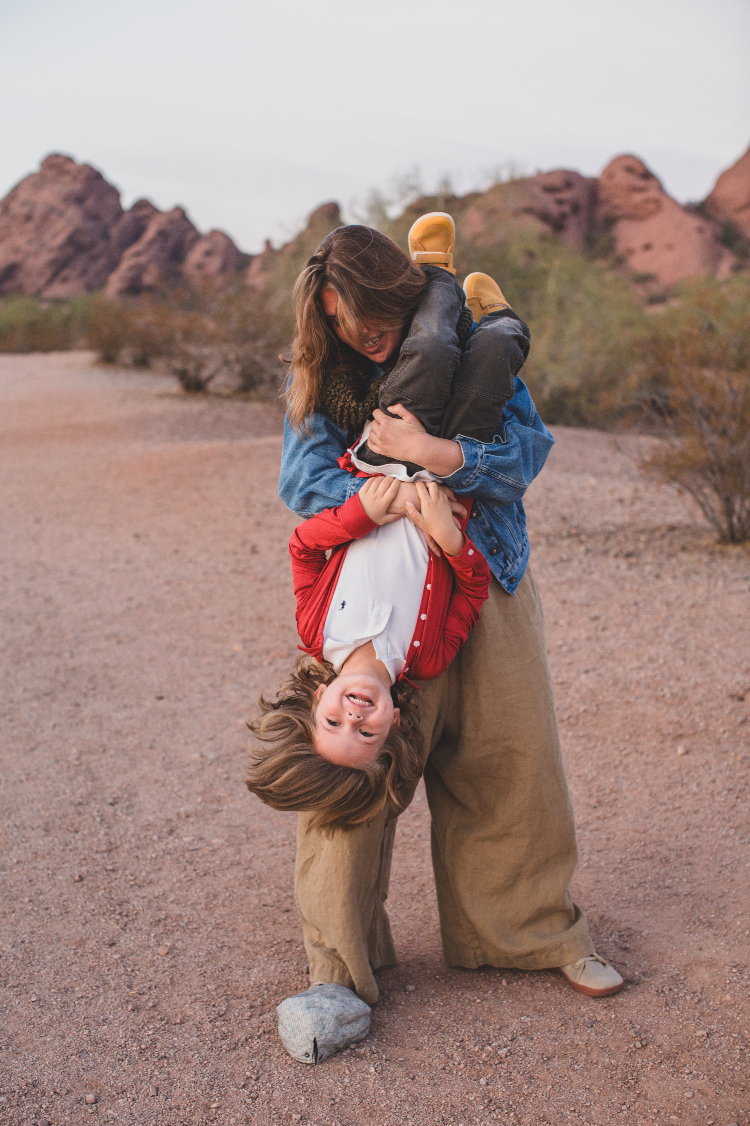 Mother and son play at family desert photo session near Papago Park in Tempe, Arizona by Phoenix based family photographer Jennifer Lind Schutsky. 
