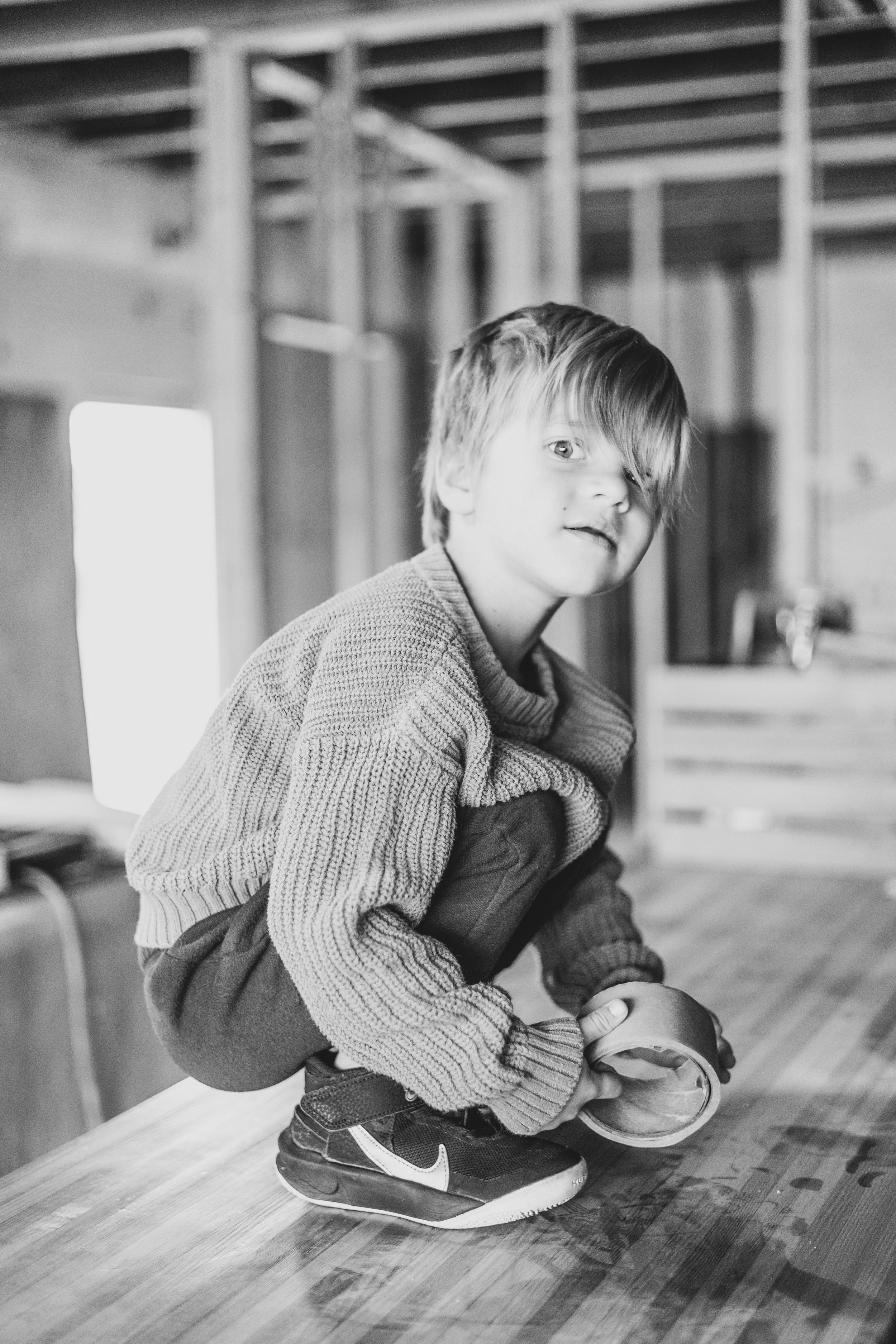 Young kid sits on the countertop in the Beal Beans’ new coffee shop coming to Sunnyslope, AZ by Arizona family photographer, Jennifer Lind Schutsky. 
