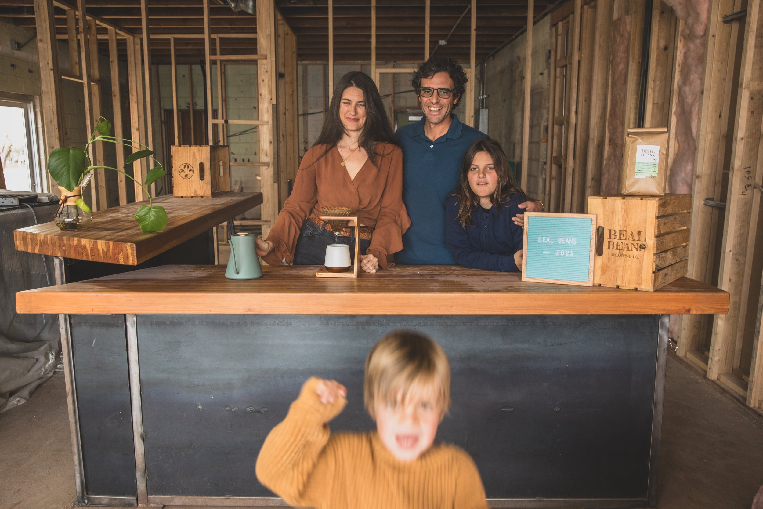 Unposed Family photo session in the unfinished Beal Beans’ new coffee shop coming to Sunnyslope, AZ by Arizona family photographer, Jennifer Lind Schutsky. 
