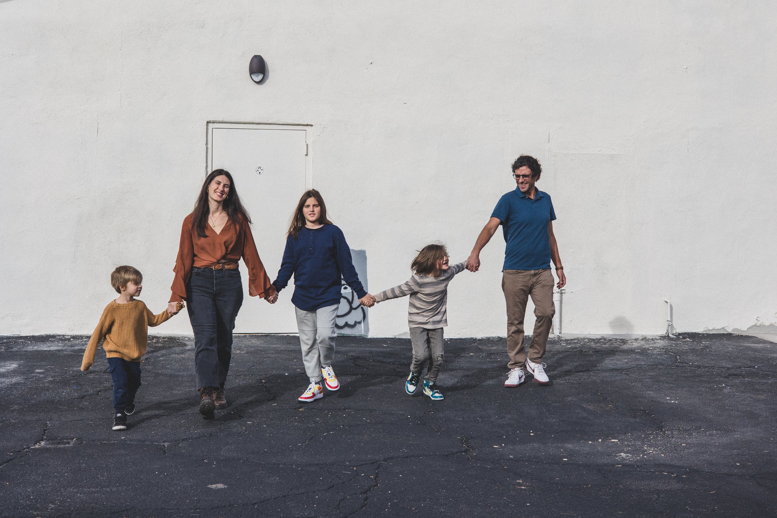 Family walks together at unique family photo session in Sunnyslope, AZ by best Phoenix family photographer, Jennifer Lind Schutsky. 