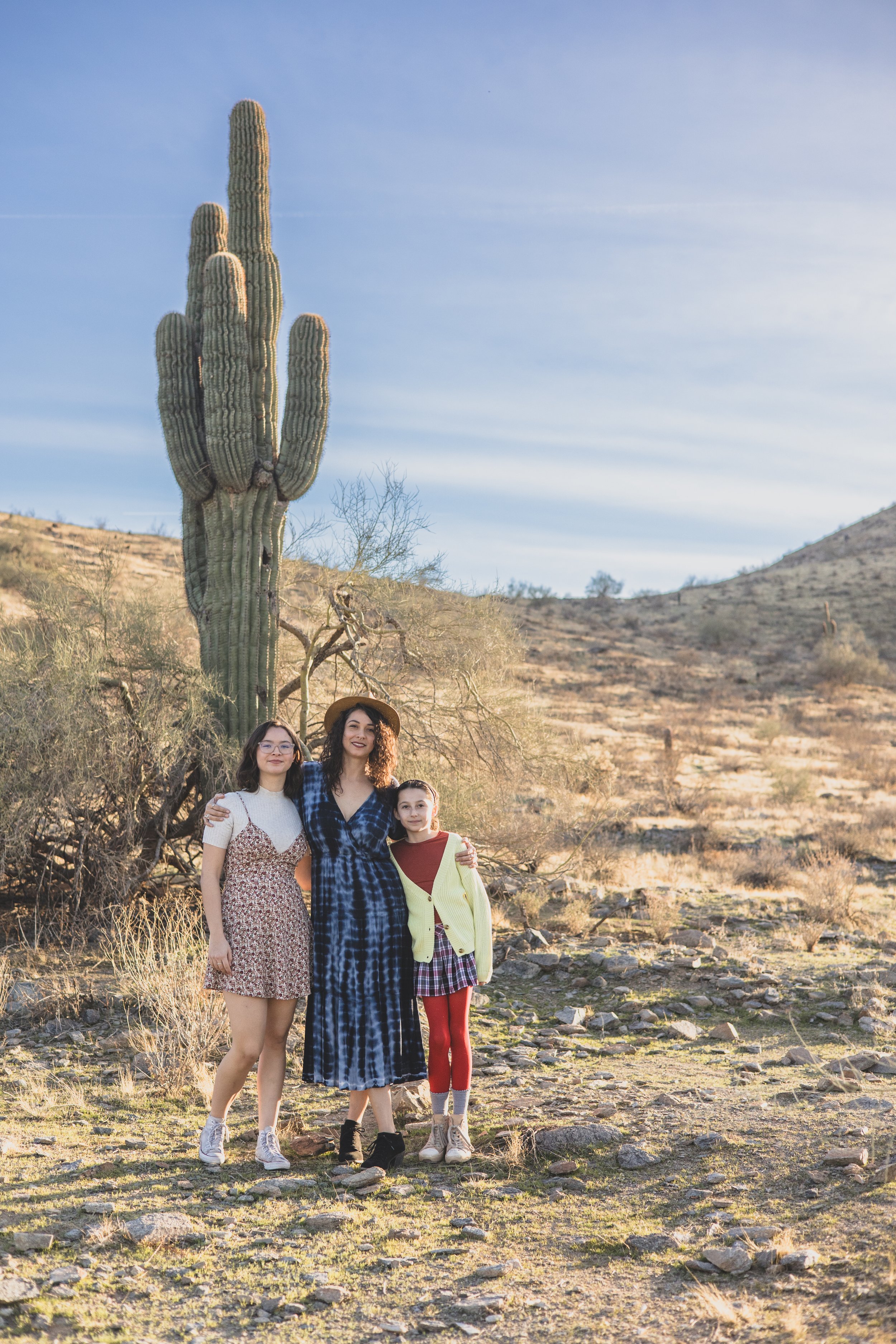 Mother and daughters pose in front of saguaro cactus during their desert family photography session with Phoenix photographer, Jennifer Lind Schutsky.