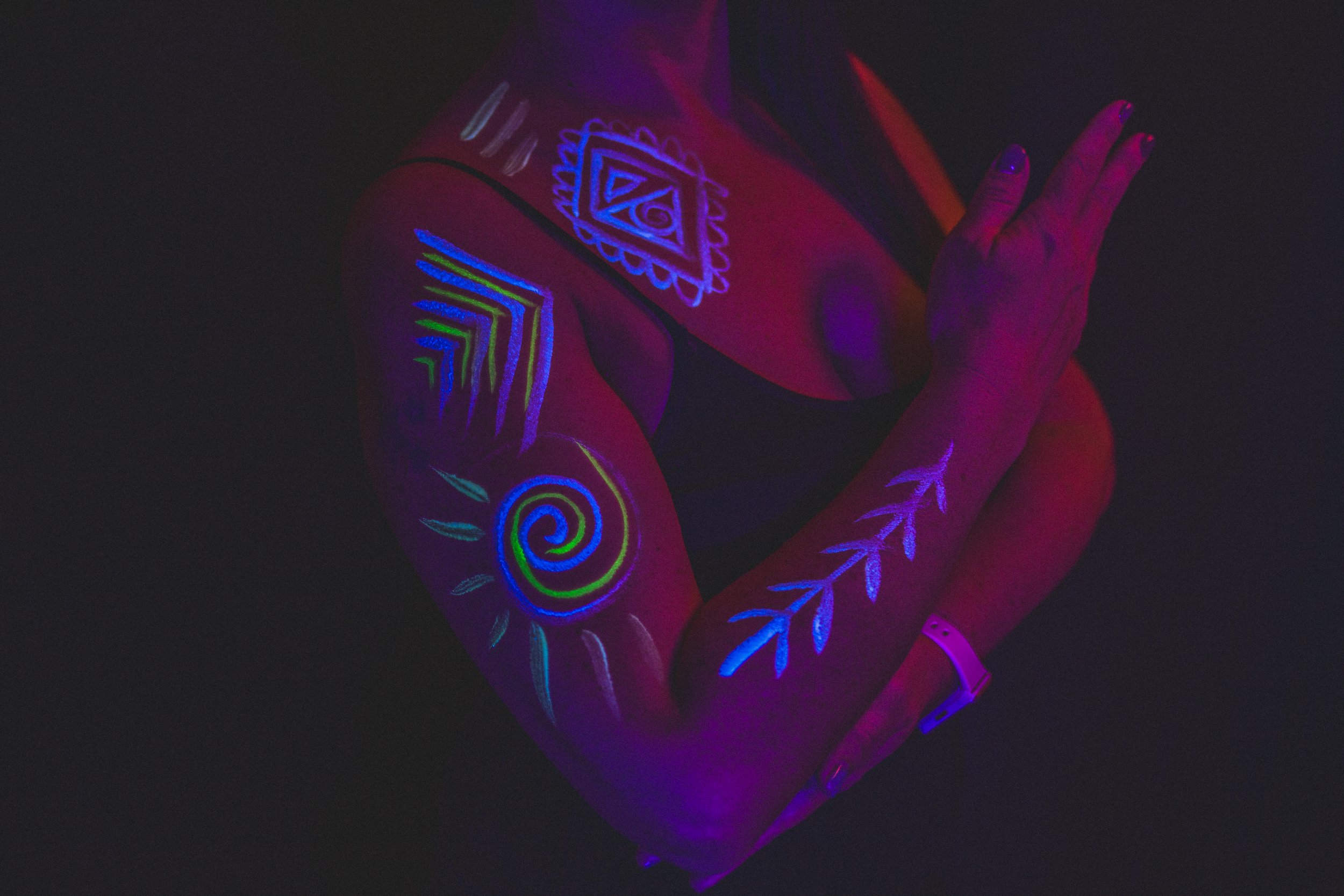 Woman poses with geometric neon body paint on her arm for alternative neon body painting creative photoshoot by phoenix body artist, La Luna Henna and photographer Jennifer Lind Schutsky.