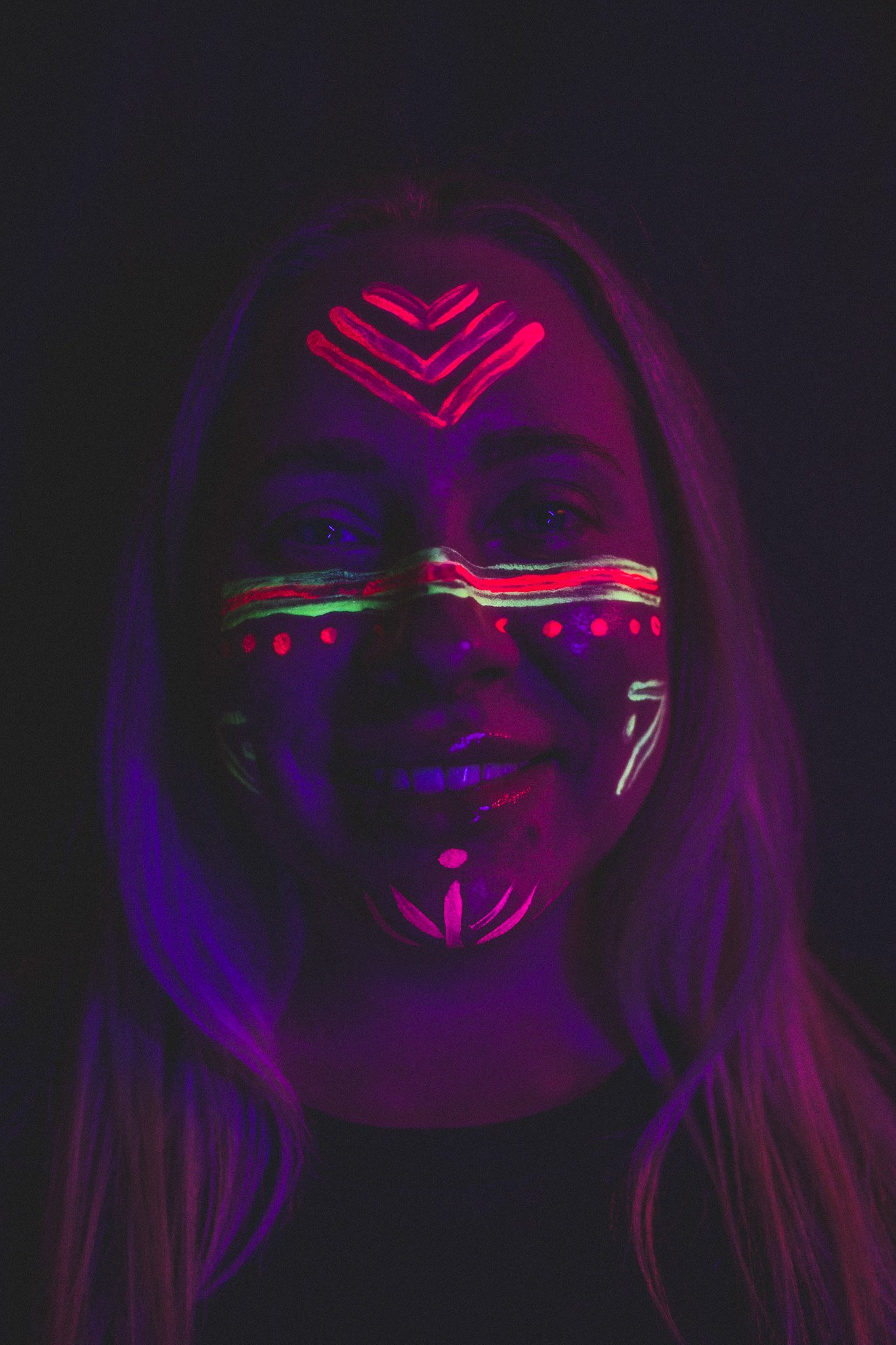 Woman poses with trendy, geometric neon body paint on their face for alternative neon body painting creative photoshoot by phoenix body artist, La Luna Henna and photographer Jennifer Lind Schutsky.