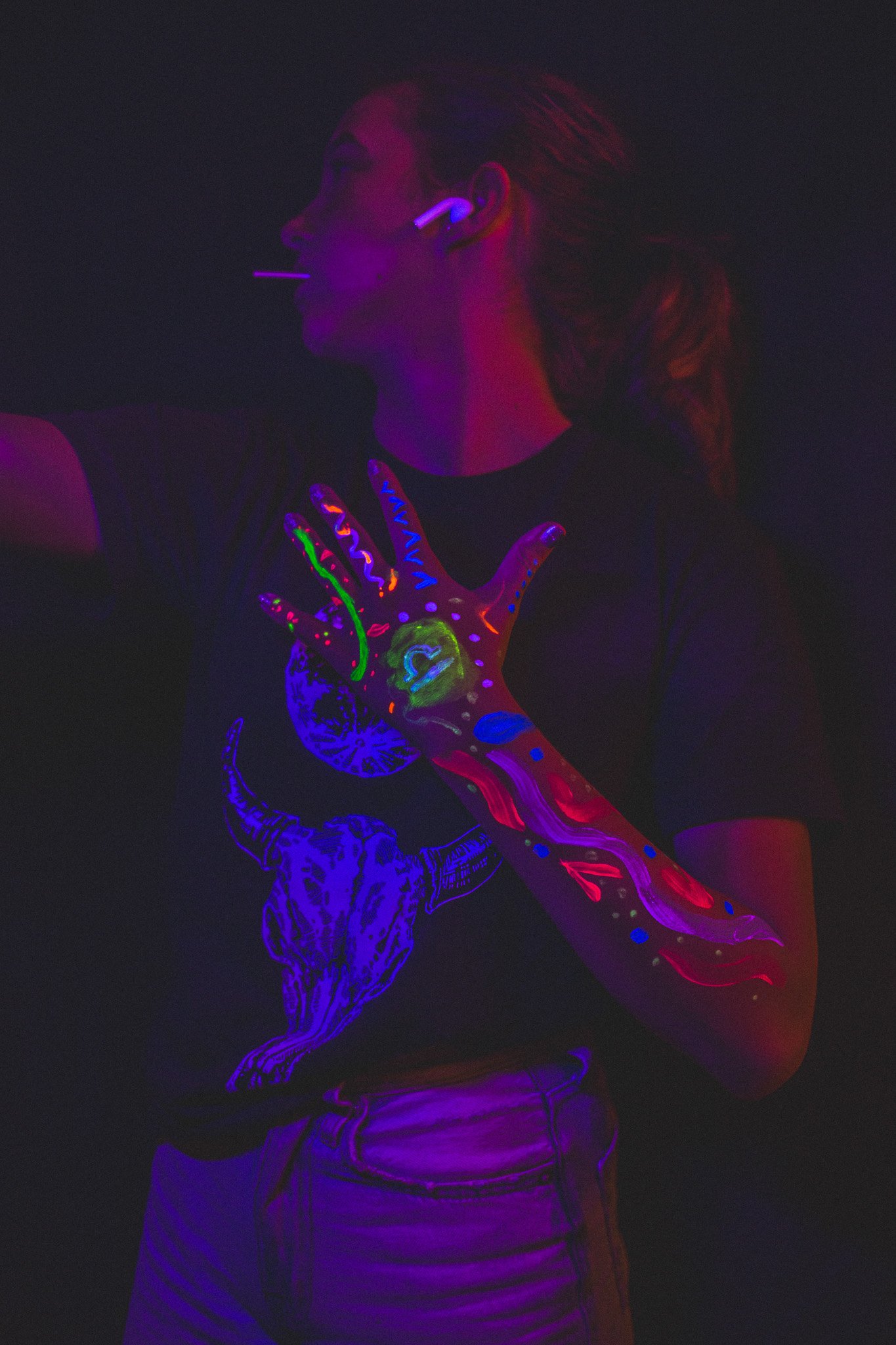 Kid poses with geometric neon body paint on their arm for alternative neon body painting creative photoshoot by phoenix body artist, La Luna Henna and photographer Jennifer Lind Schutsky.