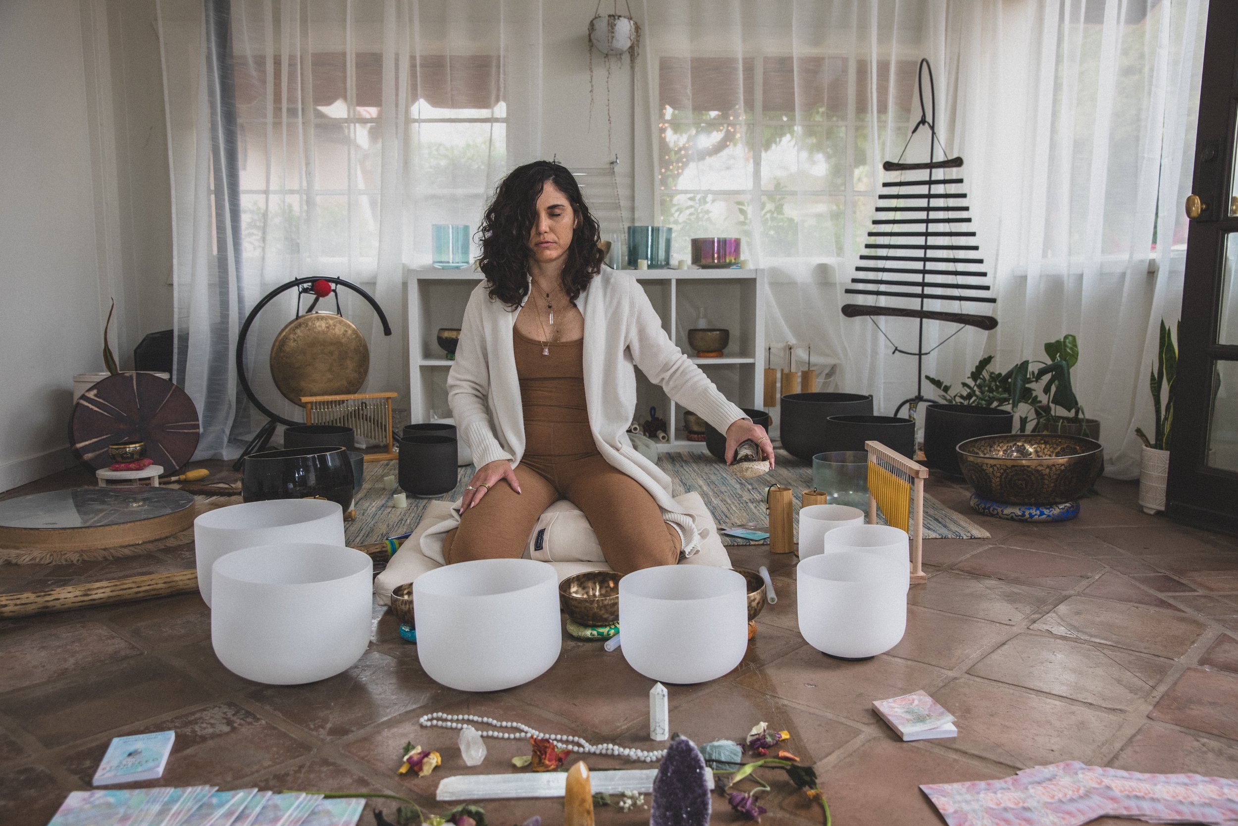 Woman prepares for sound healing ceremony with crystal sound bowls at The Portal AZ in Scottsdale, with best Arizona branding photographer, Jennifer Lind Schutsky.