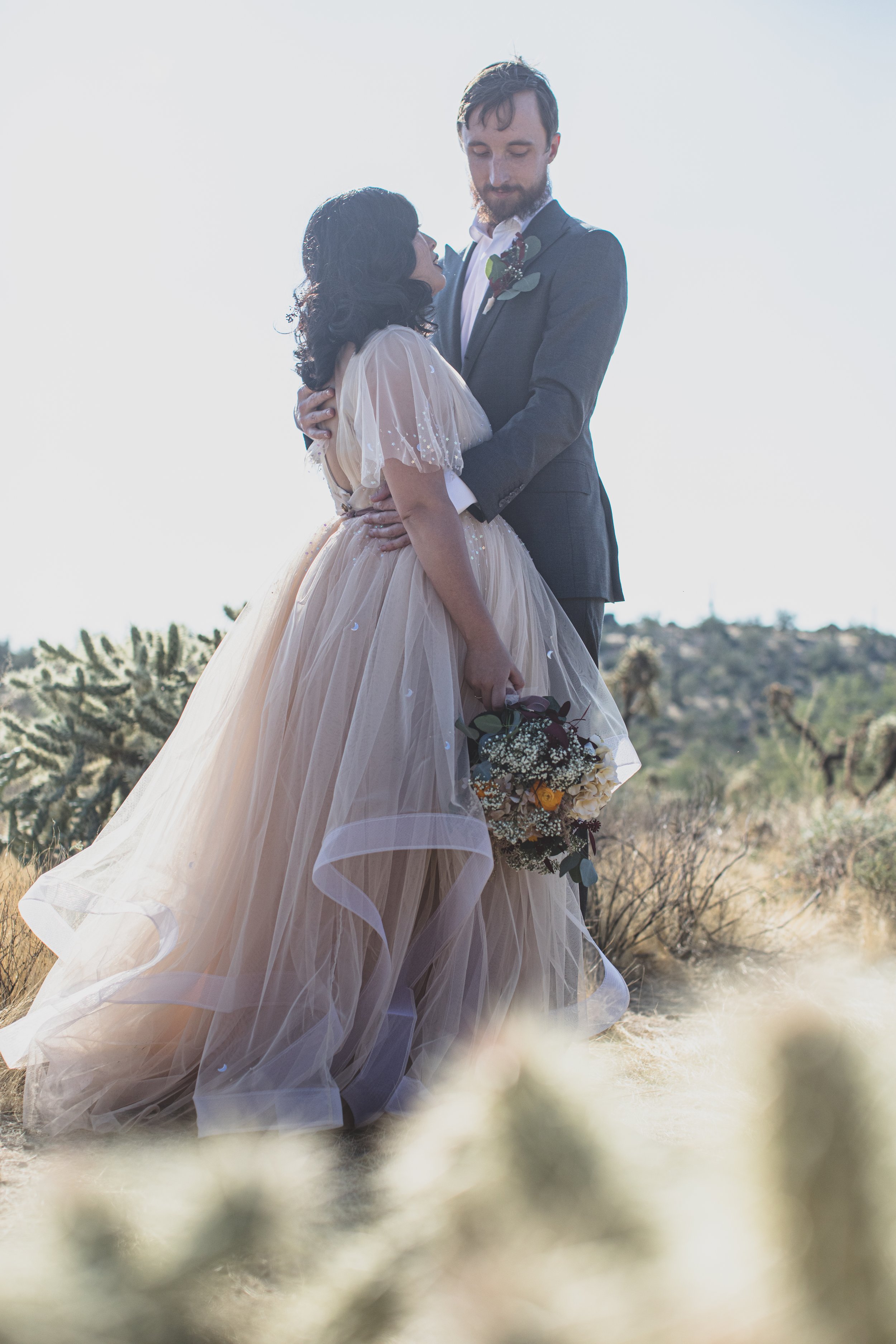 Bride and Groom share intimate moment at their Superstition Mountain intimate wedding in Arizona by outdoor wedding photographer, Jennifer Lind Schutsky. 