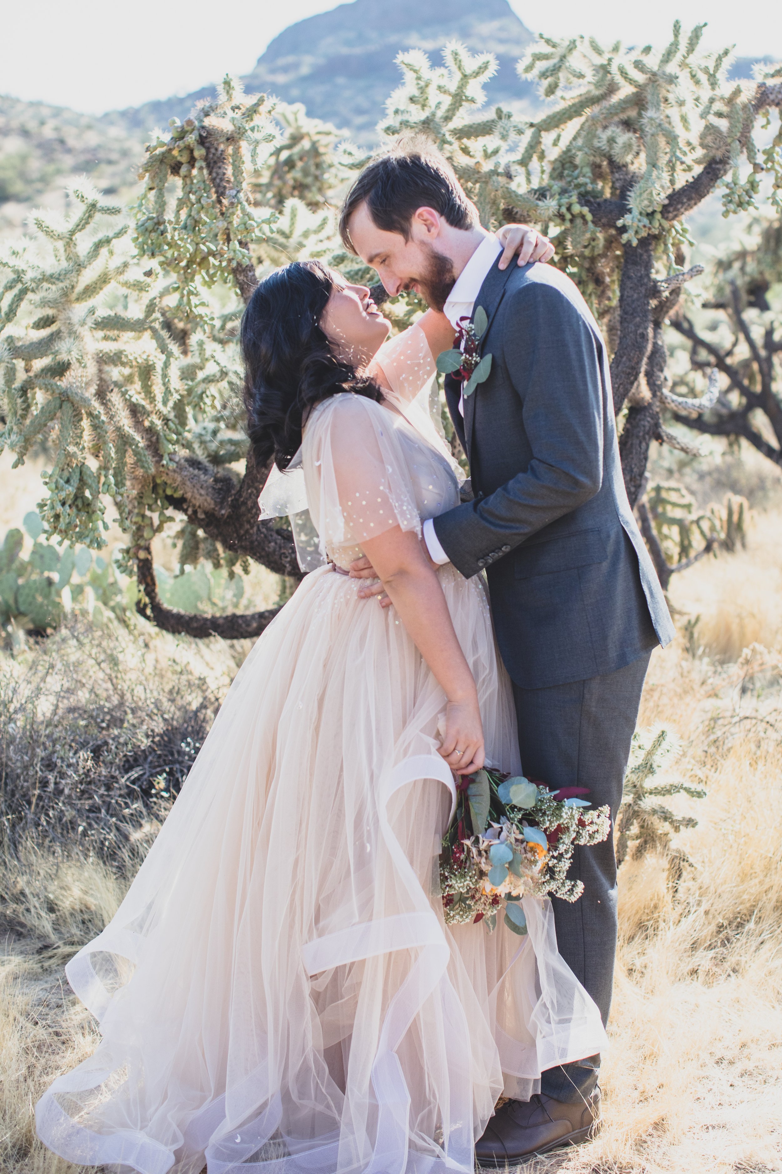 Bride and Groom share intimate kiss at their Superstition Mountain intimate wedding in Arizona by outdoor wedding photographer, Jennifer Lind Schutsky. 