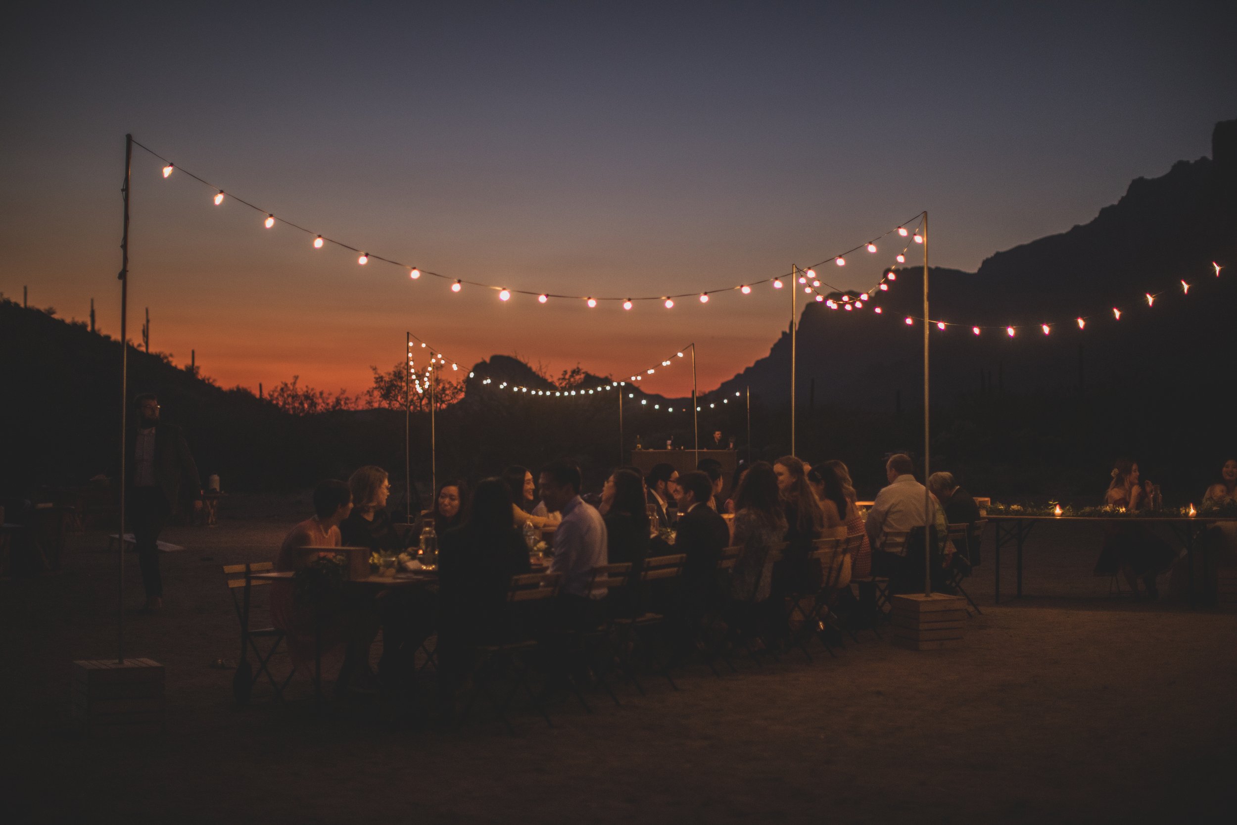 Guests mingle at the reception after intimate Superstition Mountain micro wedding near Phoenix, Arizona by destination wedding photographer, Jennifer Lind Schutsky. 