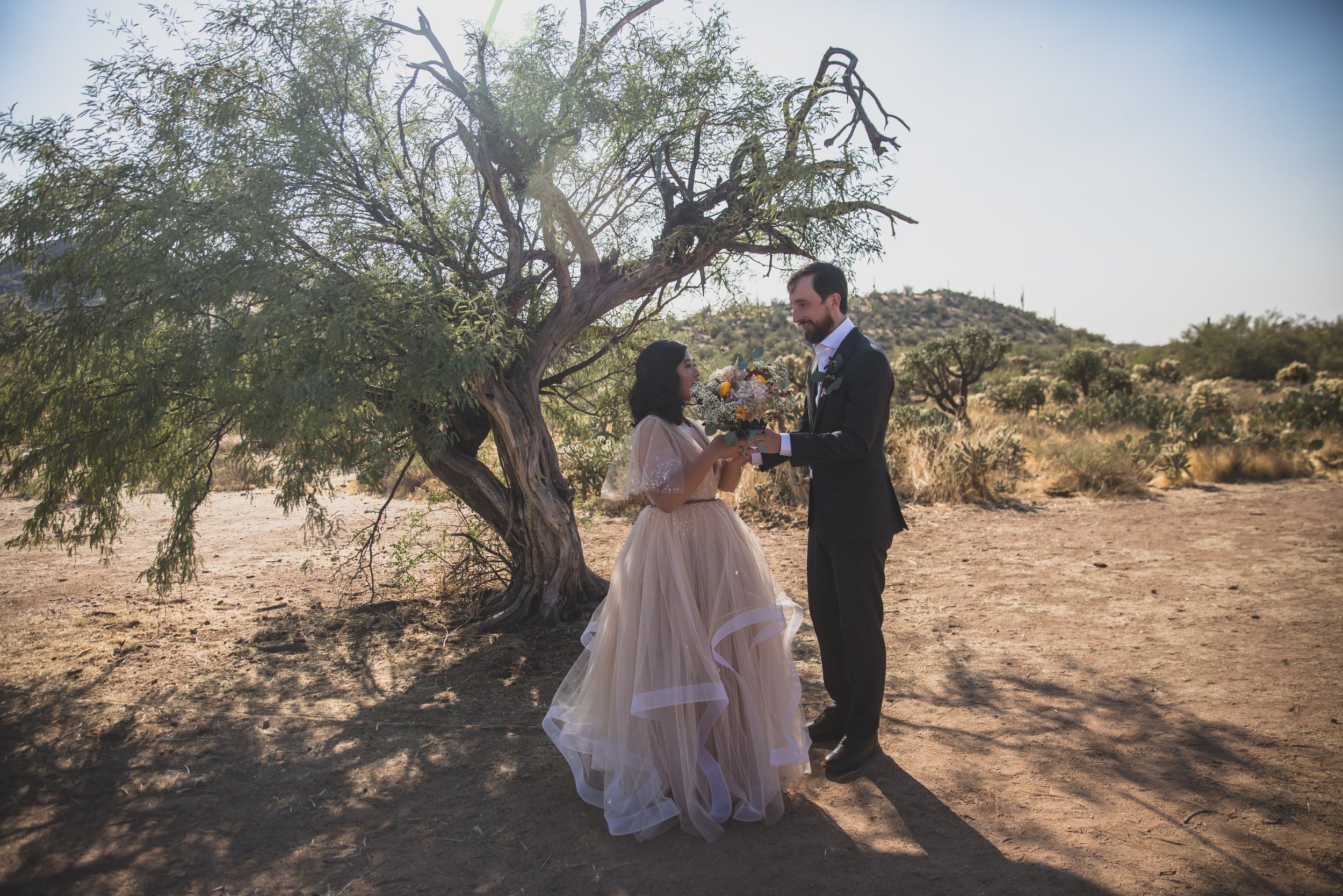 Bride and Groom sharing a private moment during their first look at their intimate Superstition Mountain micro wedding in Arizona by experienced wedding photographer, Jennifer Lind Schutsky. 