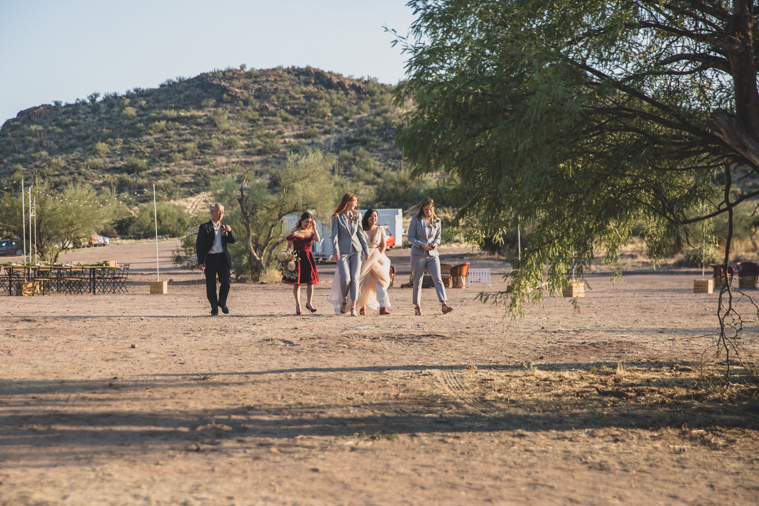 Guests walking to their seats at an intimate Superstition Mountain micro wedding in rural Arizona by Phoenix based wedding photographer, Jennifer Lind Schutsky. 