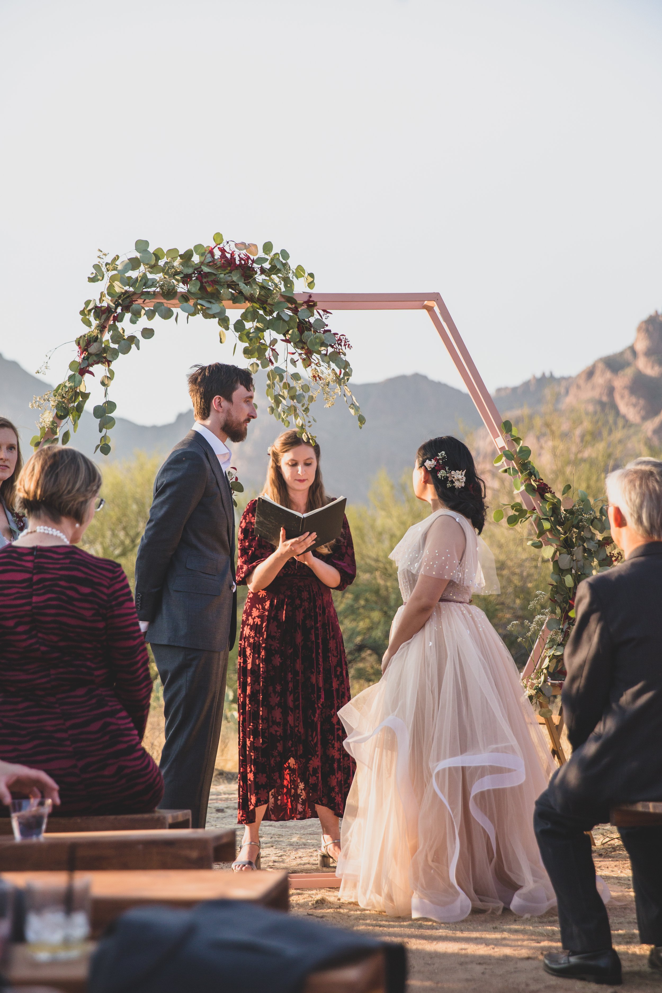 Couple looking at each other during their wedding ceremony at an intimate Superstition Mountain micro wedding in rural Arizona by Phoenix based wedding photographer, Jennifer Lind Schutsky. 