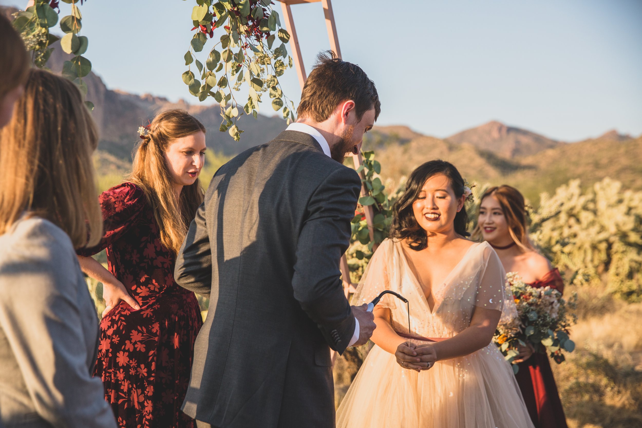 Bride and groom share their vows at their wedding ceremony at an intimate Superstition Mountain micro wedding in rural Arizona by destination wedding photographer, Jennifer Lind Schutsky. 