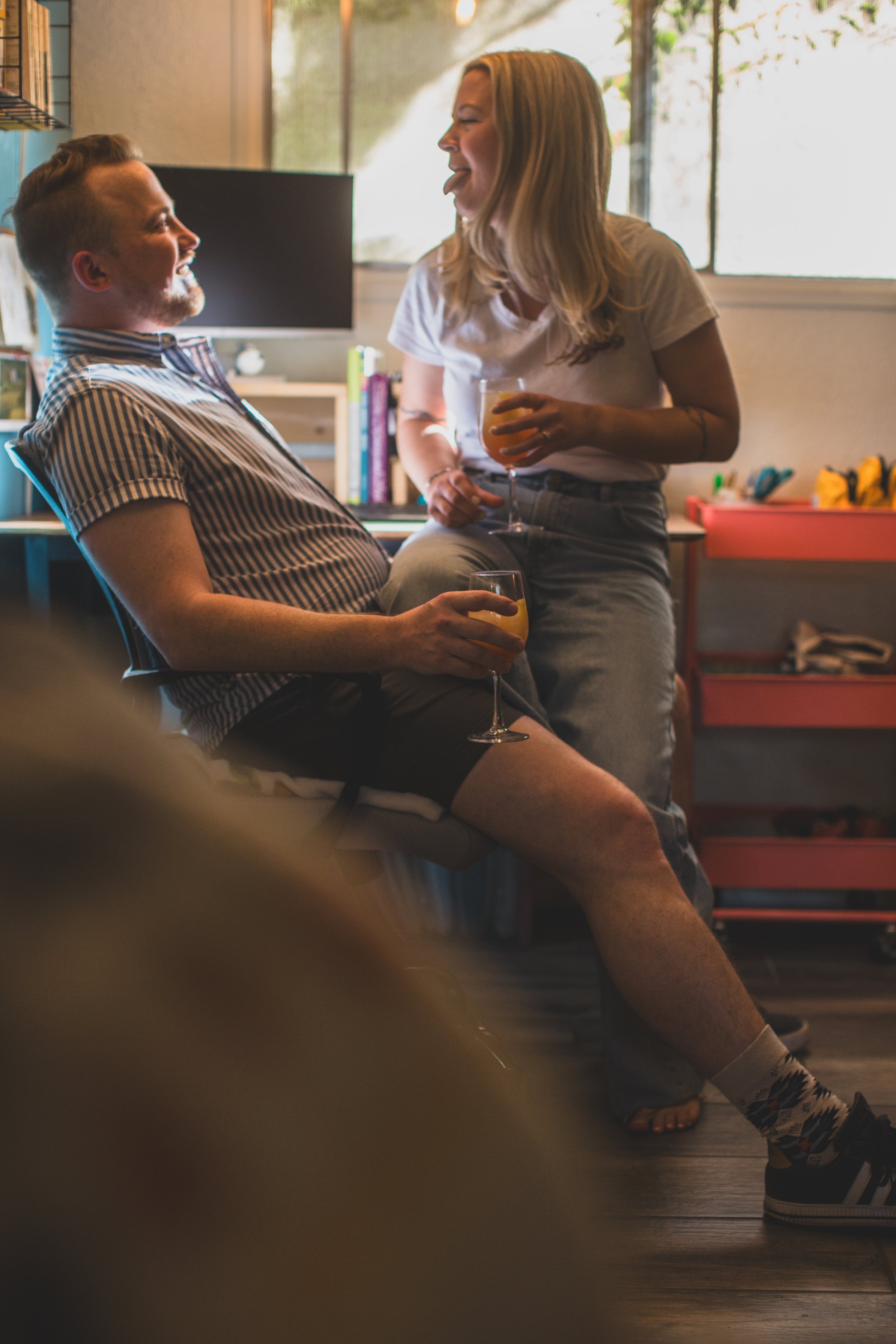 Couple have fun together during their in-home engagement photo session with Phoenix based romantic and creative wedding photographer; Jennifer Lind Schutsky. 