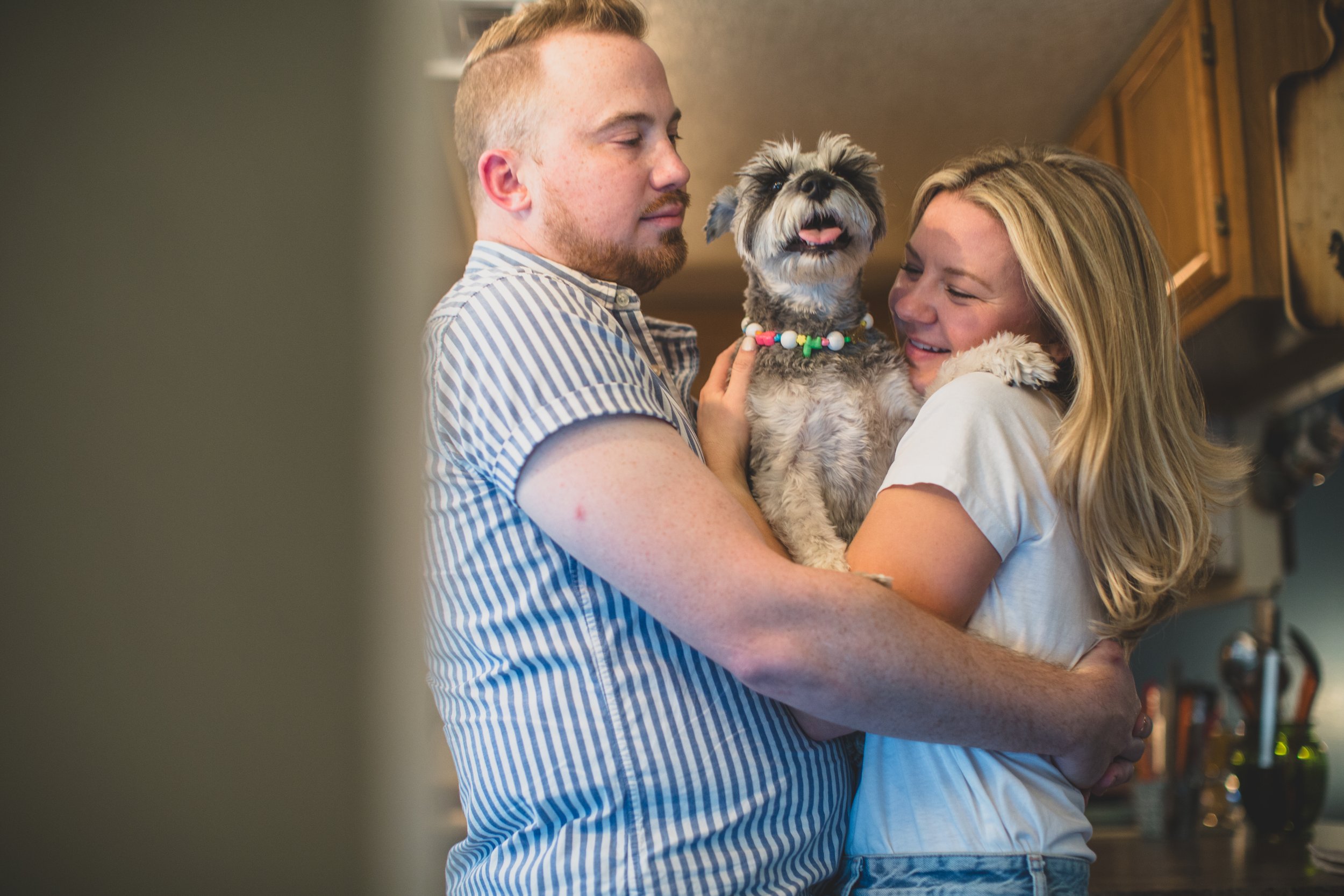 Couple have fun together during their in-home engagement photo session with Phoenix based romantic and creative wedding photographer; Jennifer Lind Schutsky. 