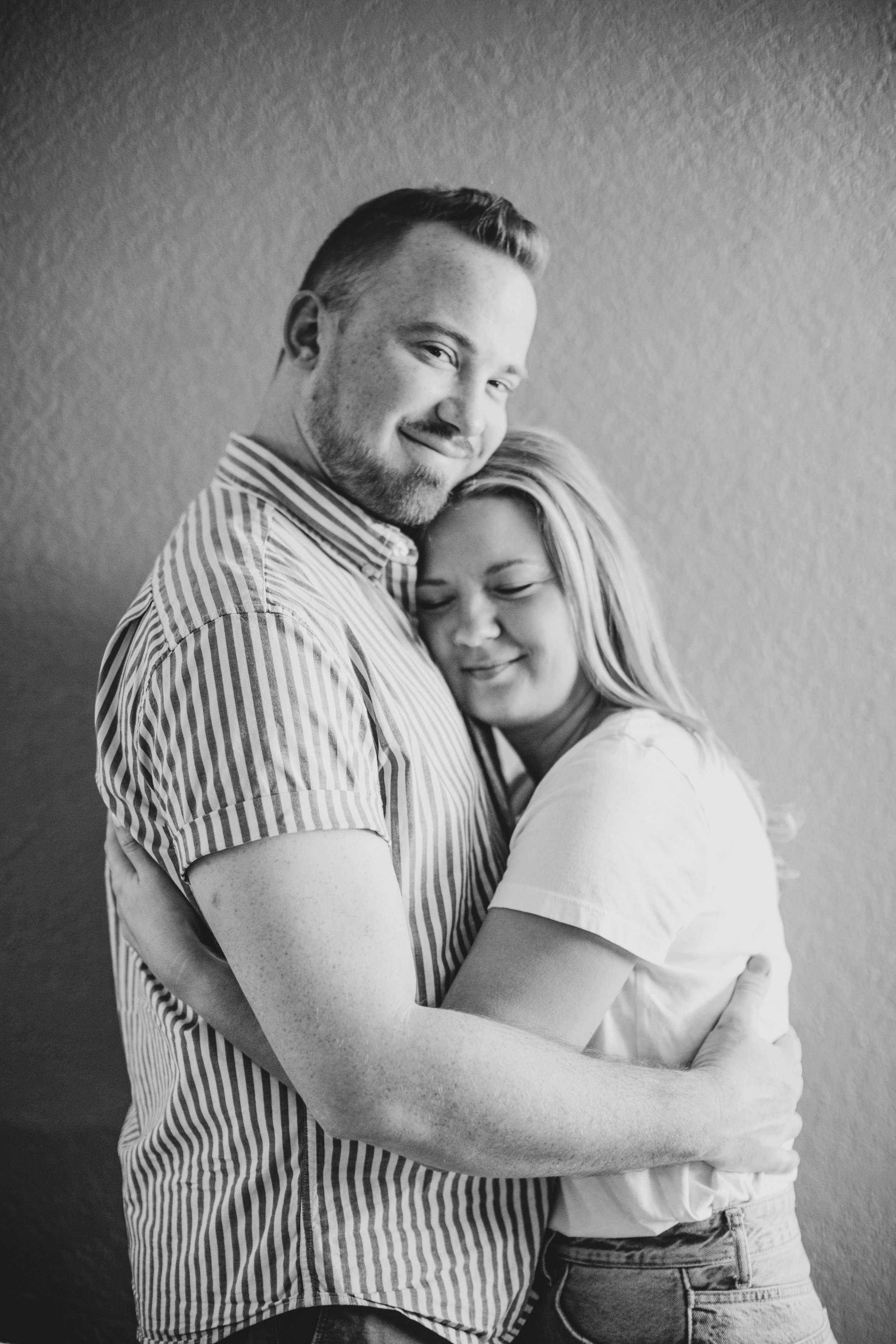 Couple get cozy and intimate during their in-home engagement photo session with Phoenix based romantic and creative wedding photographer; Jennifer Lind Schutsky. 