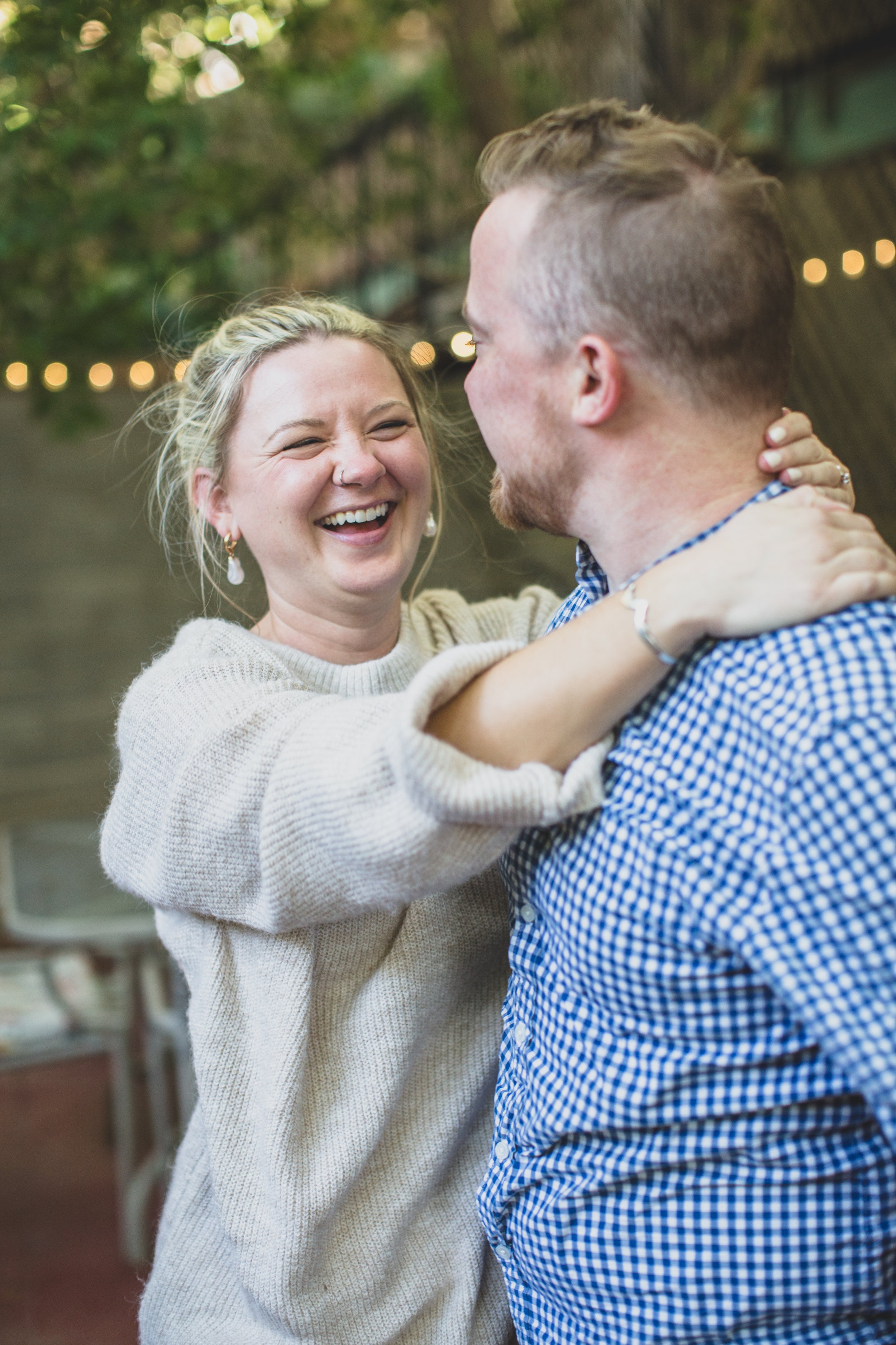 Couple dances on their patio during their in-home engagement photo session with Phoenix based creative wedding photographer; Jennifer Lind Schutsky. 