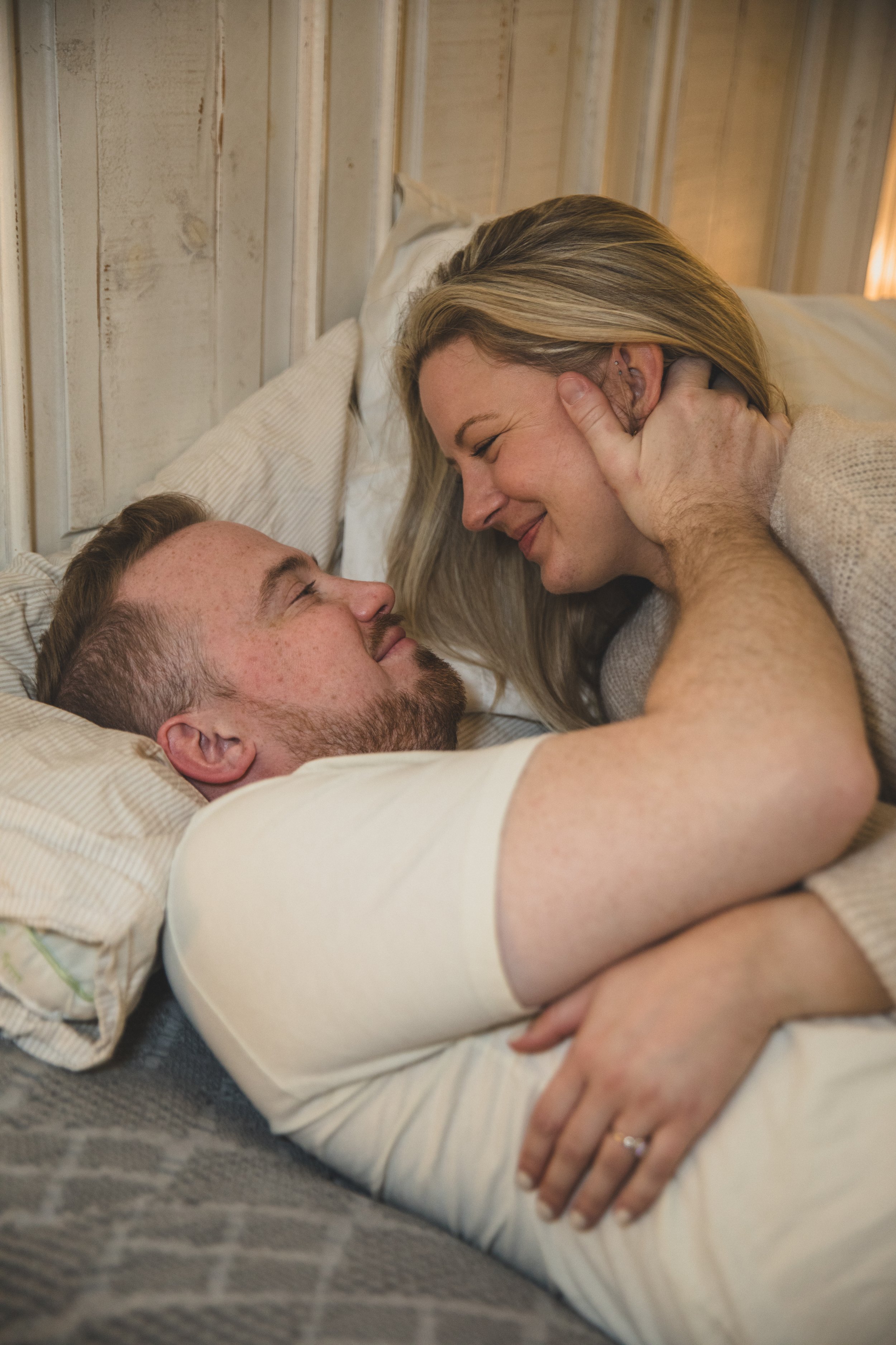 Couple get cozy and intimate during their in-home engagement photo session with Phoenix based romantic and creative wedding photographer; Jennifer Lind Schutsky. 