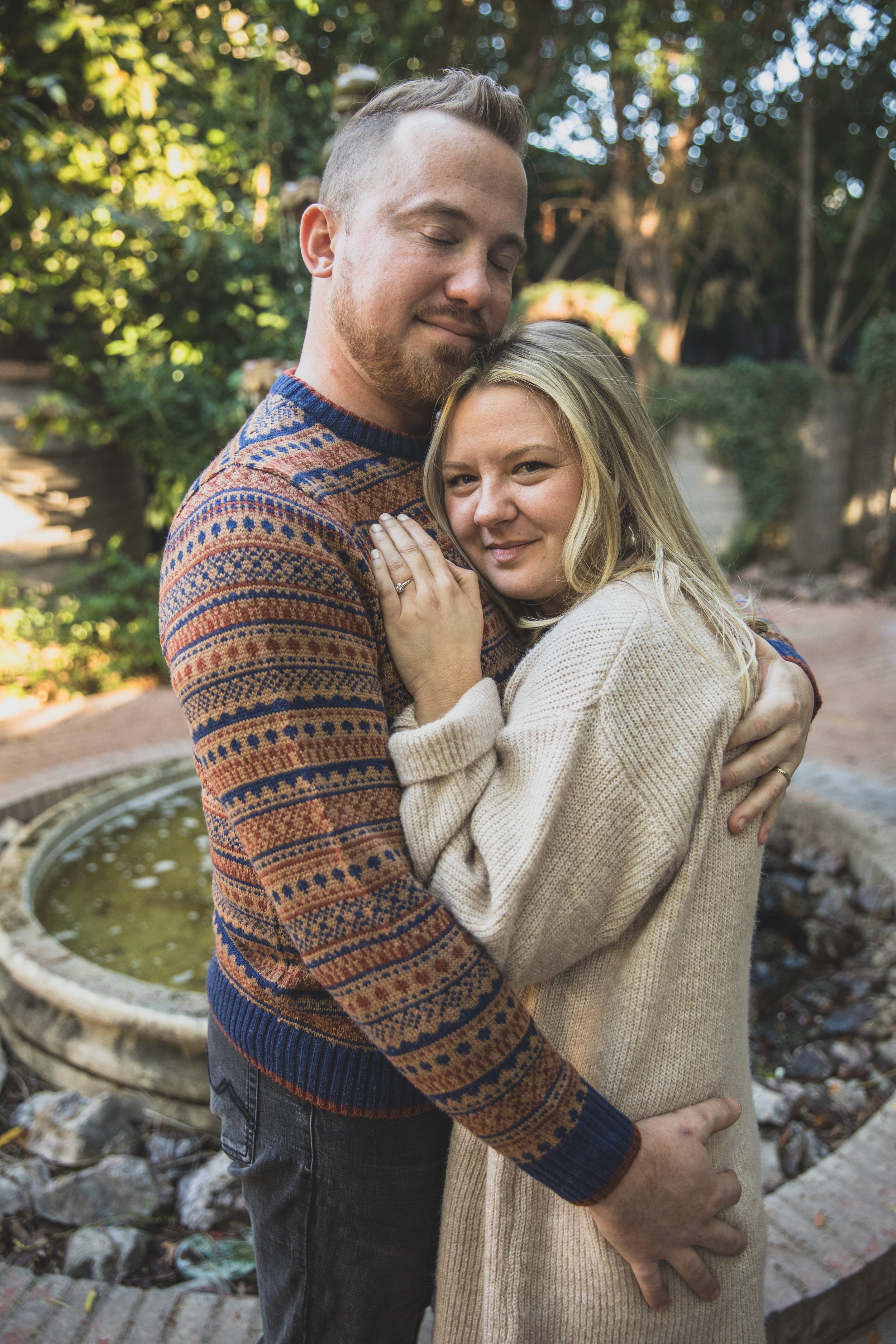 Couple pose cuddled up together during their in-home engagement photo session with Phoenix based romantic engagement photographer; Jennifer Lind Schutsky. 