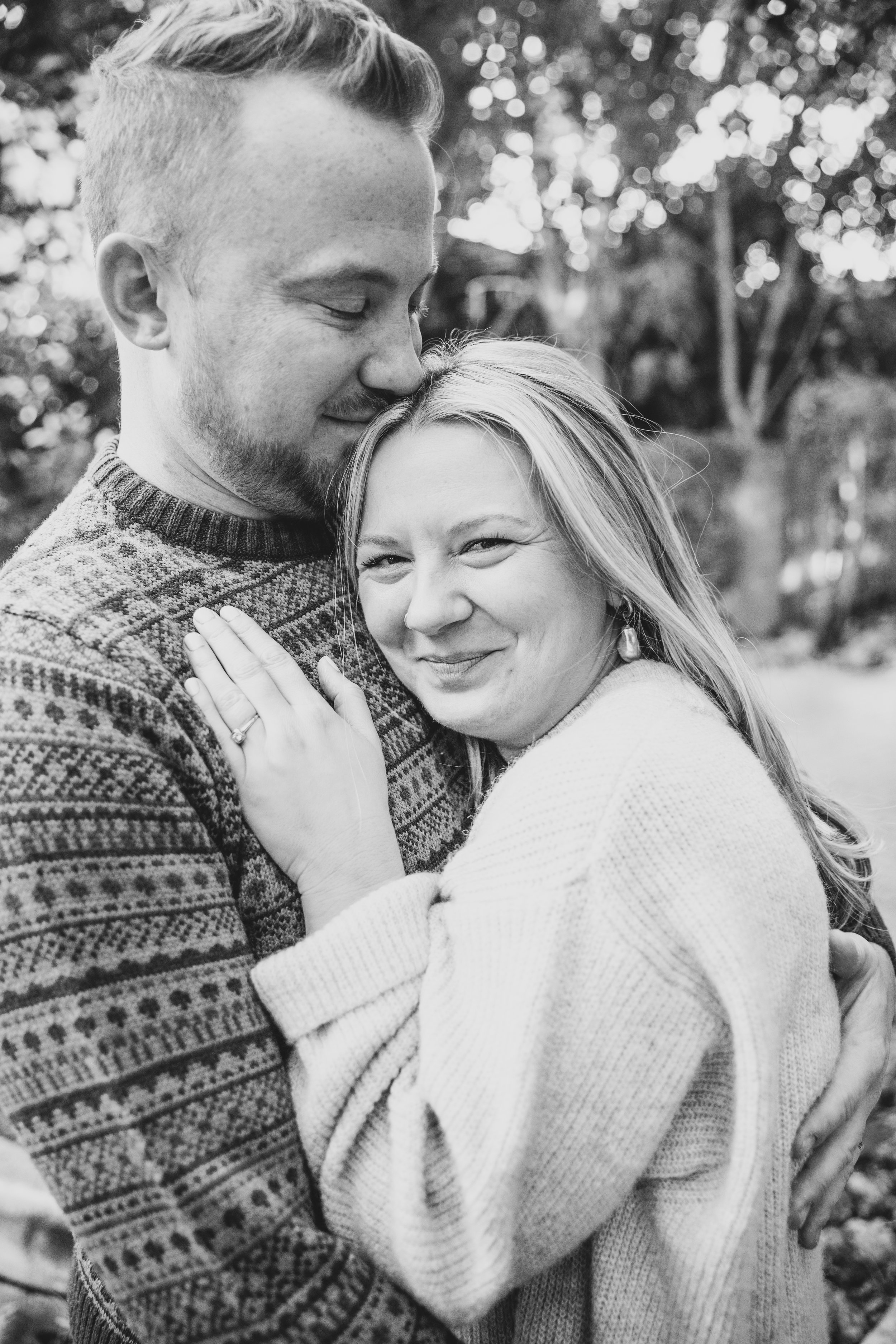 Couple pose cuddled up together during their in-home engagement photo session with Phoenix based romantic engagement photographer; Jennifer Lind Schutsky. 