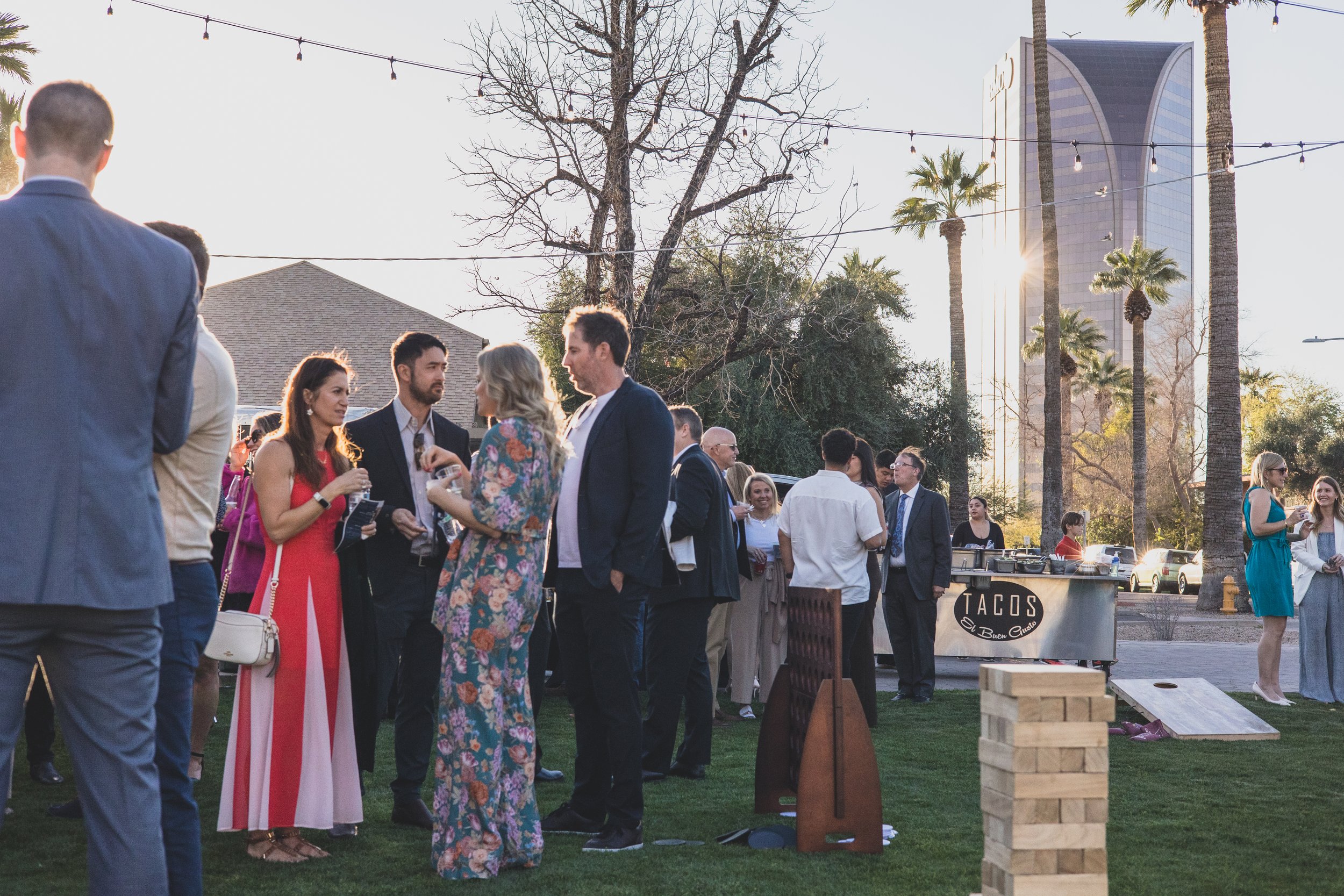 Guests at a Sunset Private Corporate on the lawn of Historic Downtown Phoenix's newest venue, the Coronado House by Corporate Event Photographer in Phoenix; Jennifer Lind Schutsky.