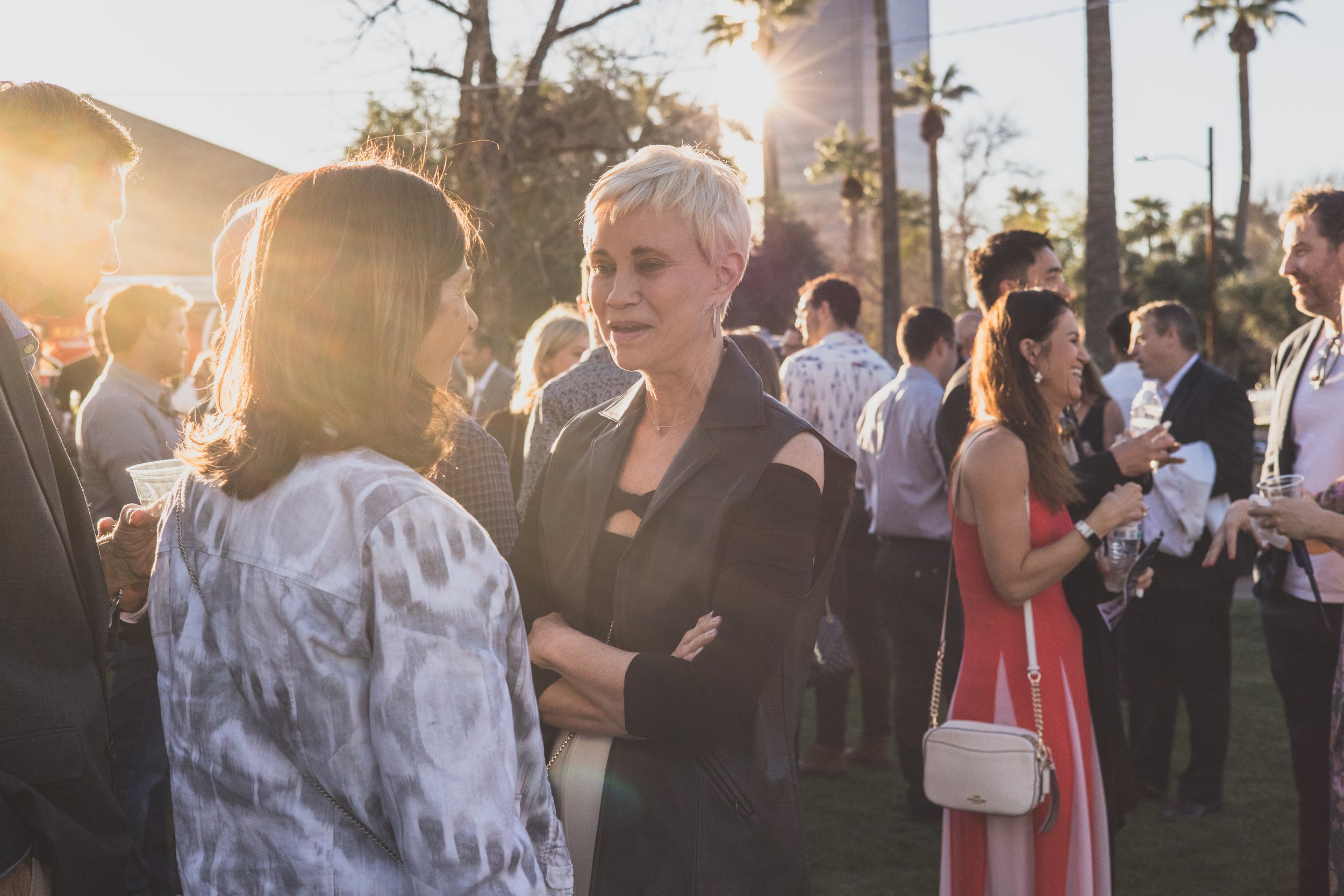 Guests talking at a Private Corporate at sunset in the Coronado House a Historic Downtown Phoenix's newest venue, by Candid Corporate Event Photographer; Jennifer Lind Schutsky.