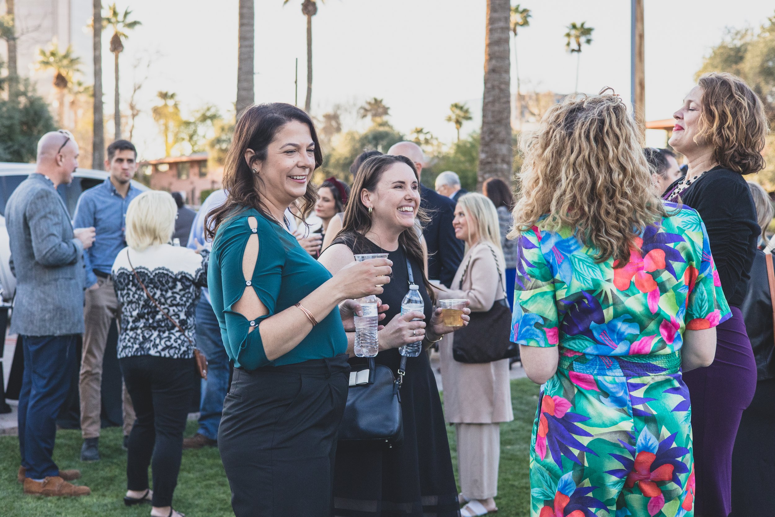 Guests having fun at a Private Corporate at sunset in the Coronado House a Historic Downtown Phoenix's newest venue, by Candid Corporate Event Photographer; Jennifer Lind Schutsky.
