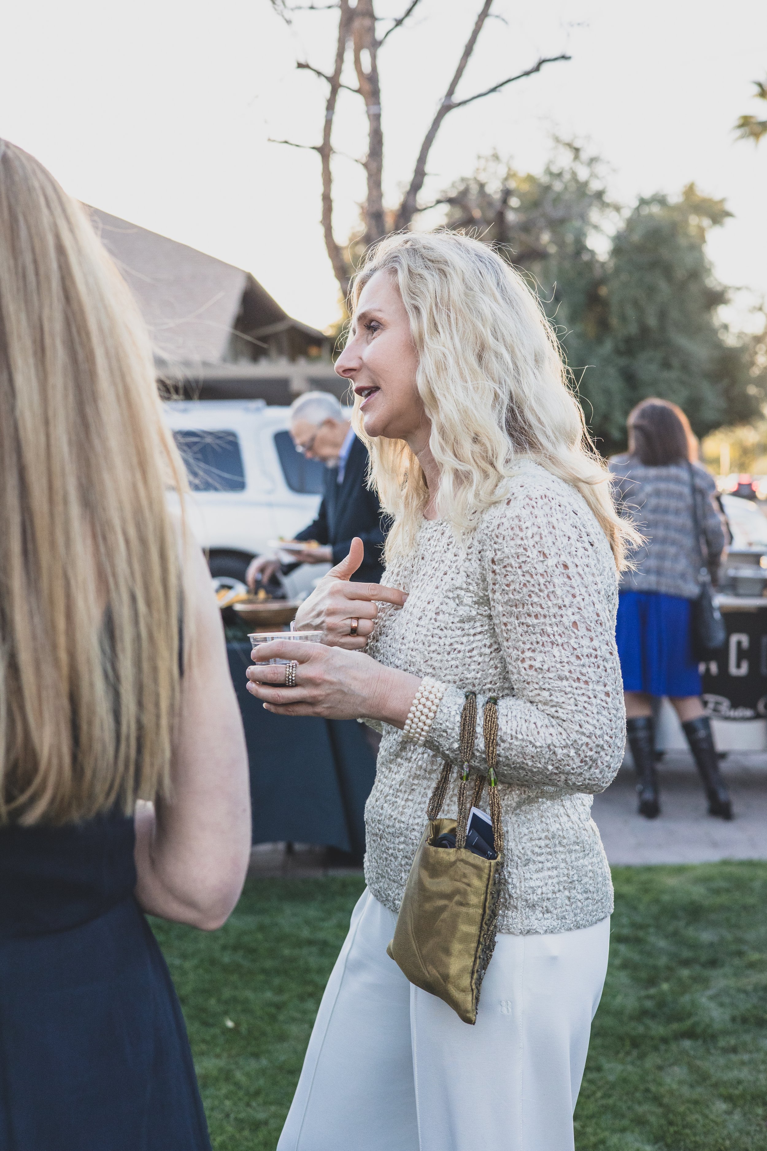 Guests having fun at a Private Corporate at sunset in the Coronado House a Historic Downtown Phoenix's newest venue, by Candid Corporate Event Photographer; Jennifer Lind Schutsky.