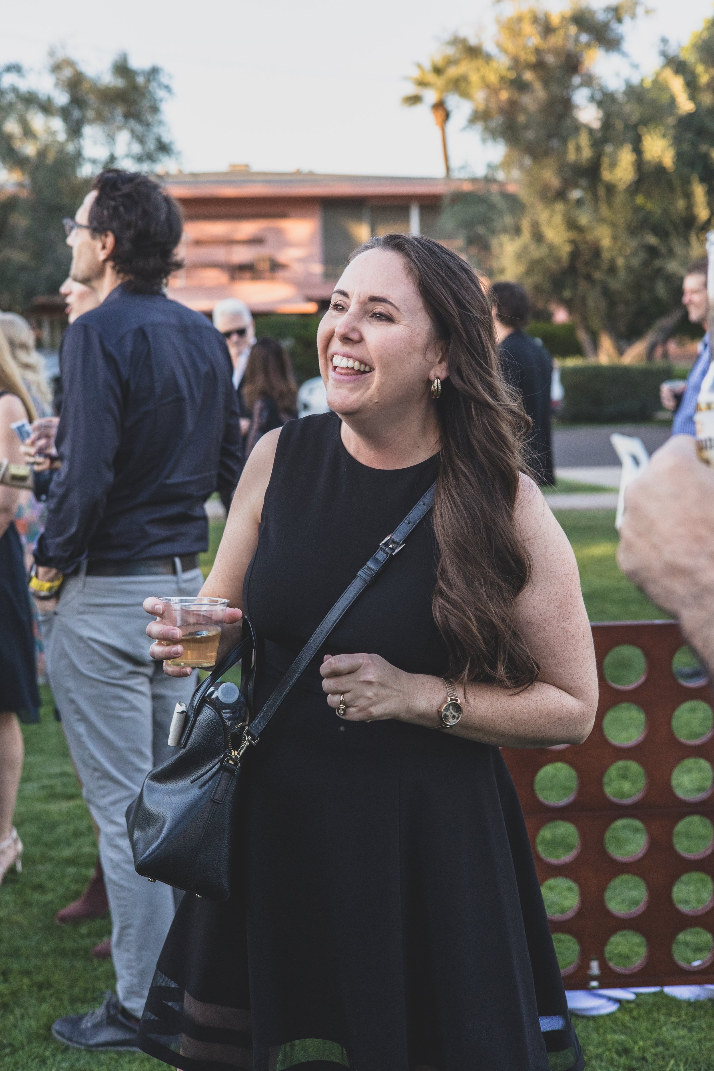 Guests having fun at a Private Corporate at sunset in the Coronado House a Historic Downtown Phoenix's newest venue, by Candid Corporate Event Photographer; Jennifer Lind Schutsky.