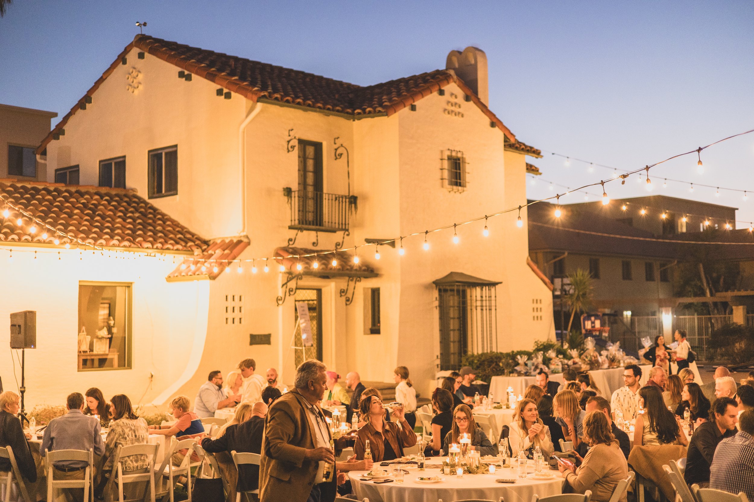 Guests at dinner during a Private Corporate event at the Coronado House a Historic Downtown Phoenix's newest venue, by Professional Corporate Event Photographer; Jennifer Lind Schutsky.