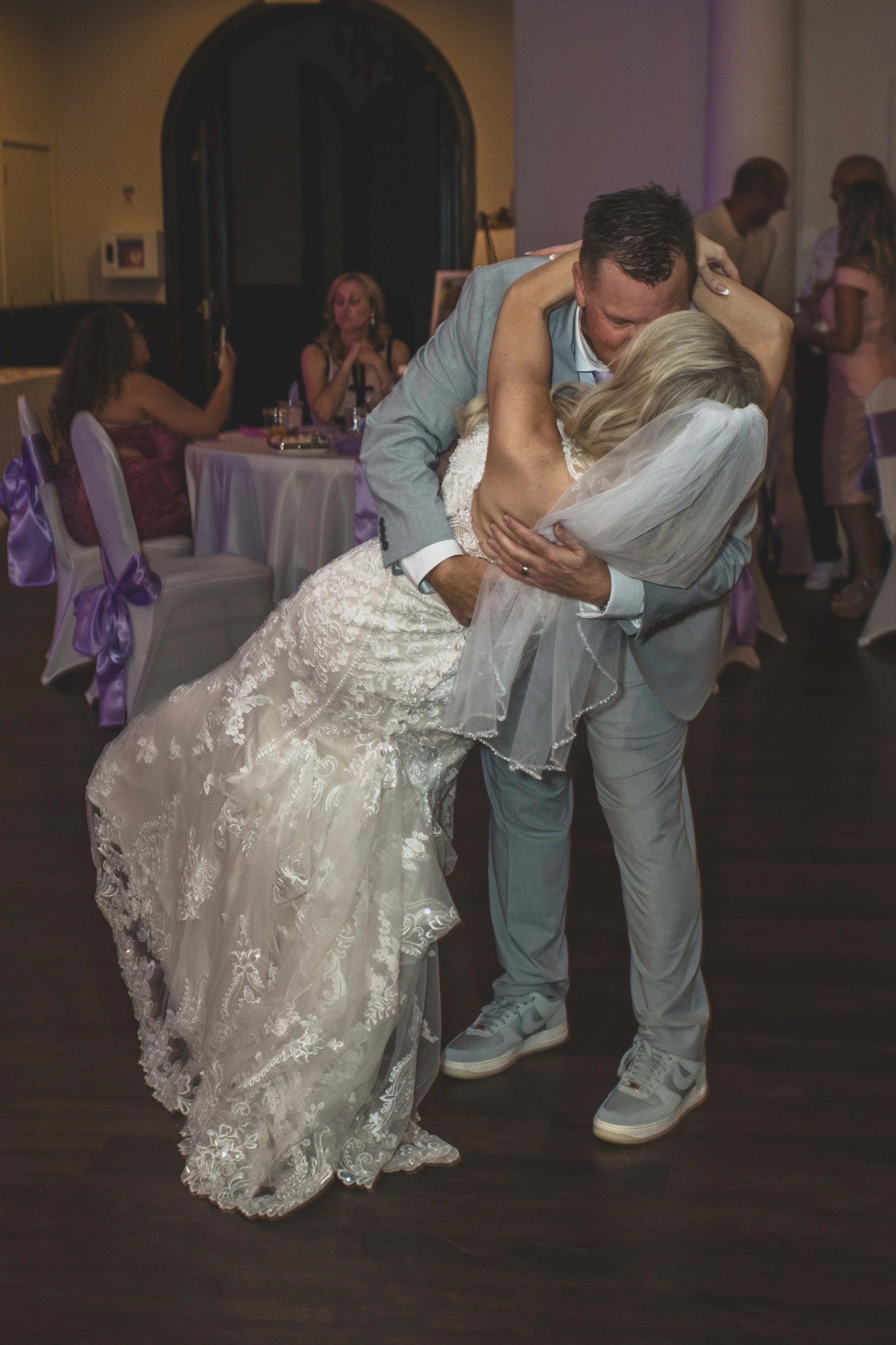 Newlyweds at wedding reception at Val Vista Lakes Event Venue by experienced wedding photographer in Arizona, Jennifer Lind Schutsky.