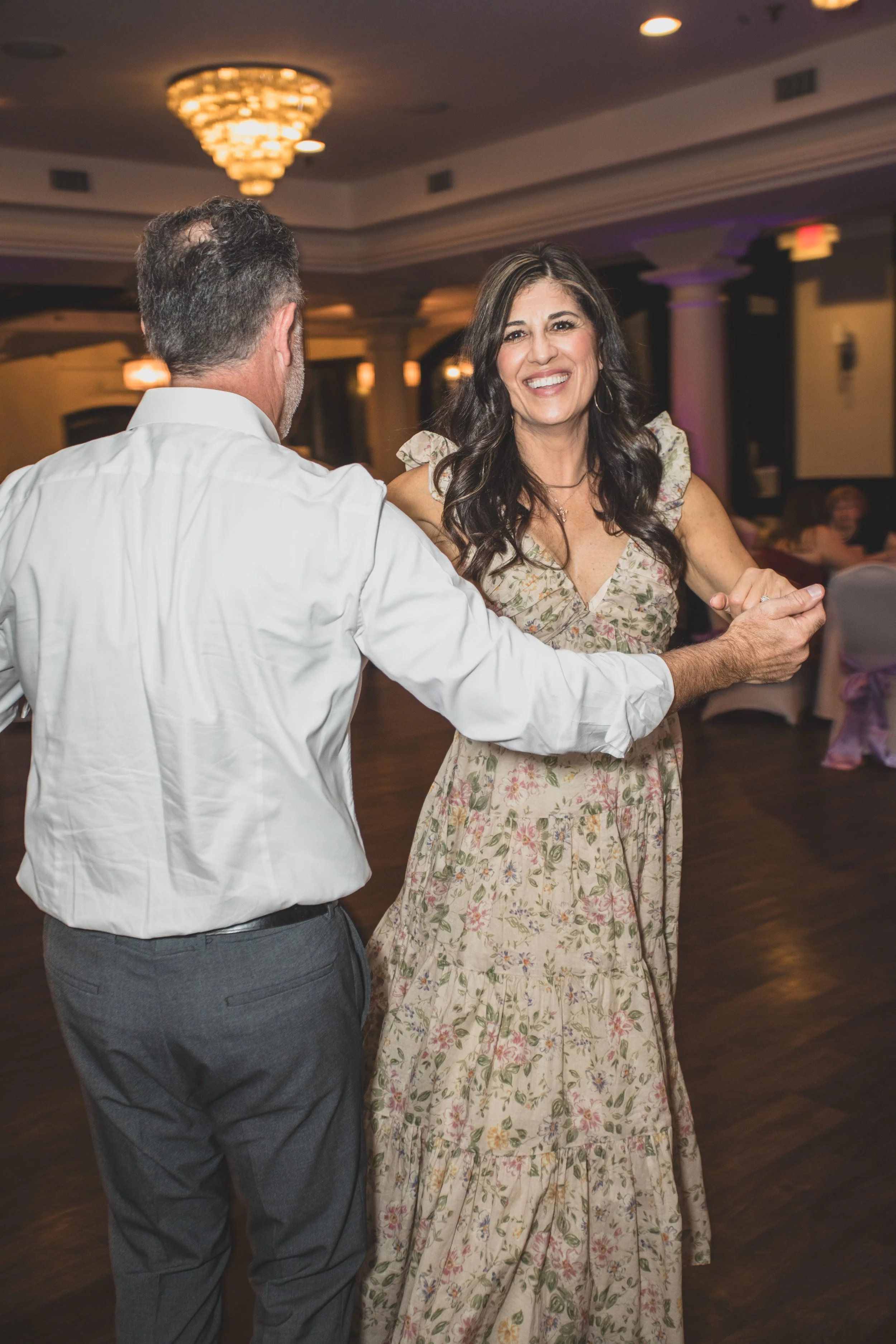 Guests at wedding reception at Val Vista Lakes Event Venue by experienced wedding photographer in Arizona, Jennifer Lind Schutsky.