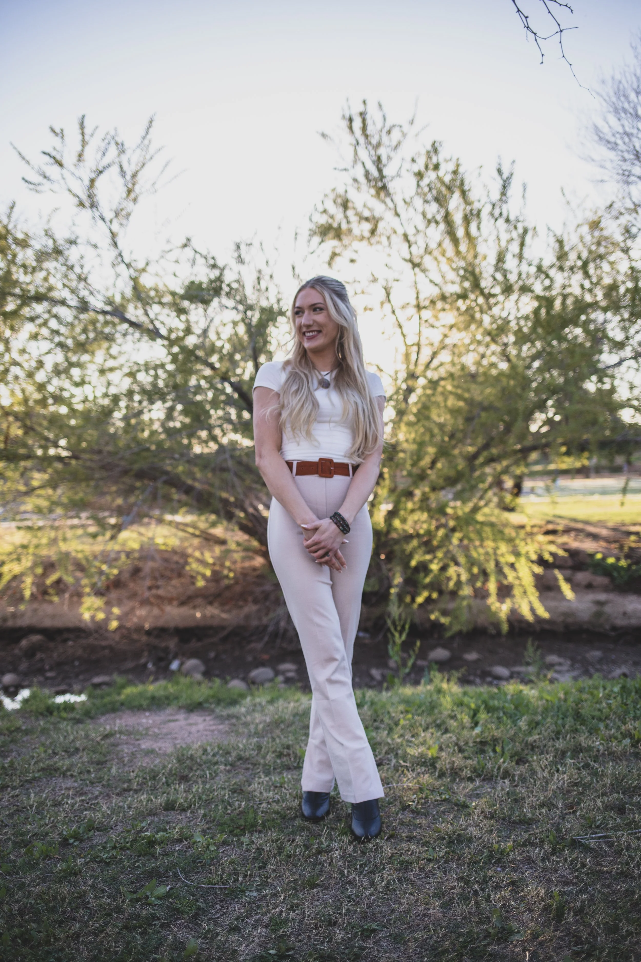 Woman poses in front of natural backdrop for professional headshots by Scottsdale based Corporate Branding Photographer, Jennifer Lind Schutsky in Arizona.