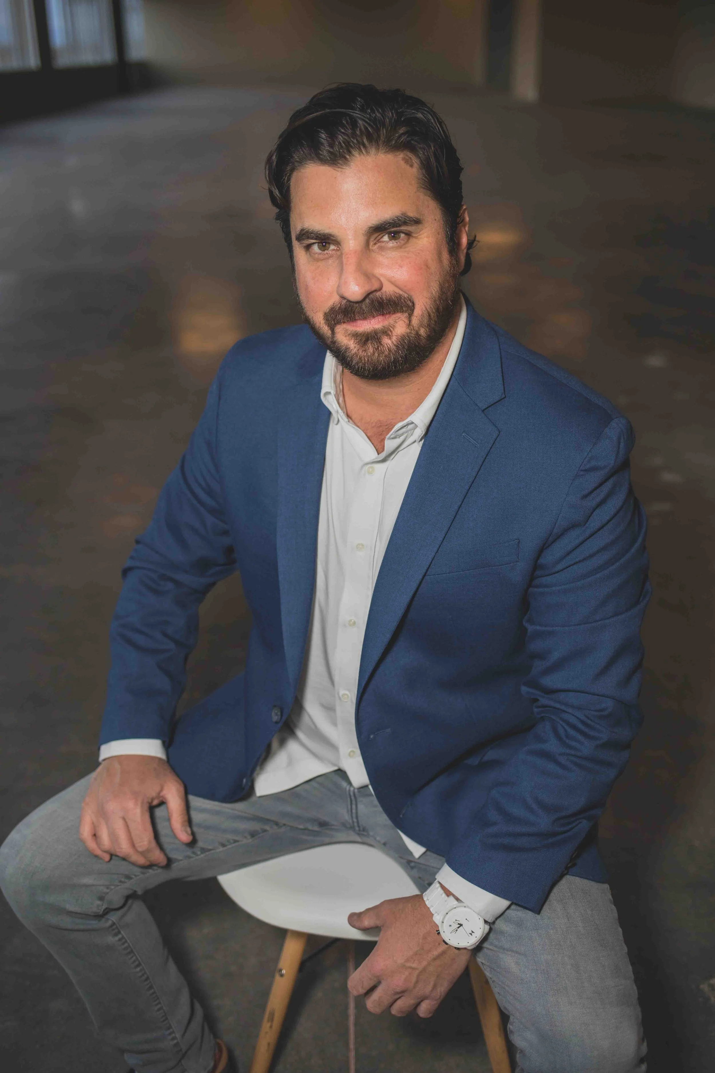 Man poses in vacant office construction site for professional headshots by best branding photographer in Phoenix, Arizona; Jennifer Lind Schutsky.