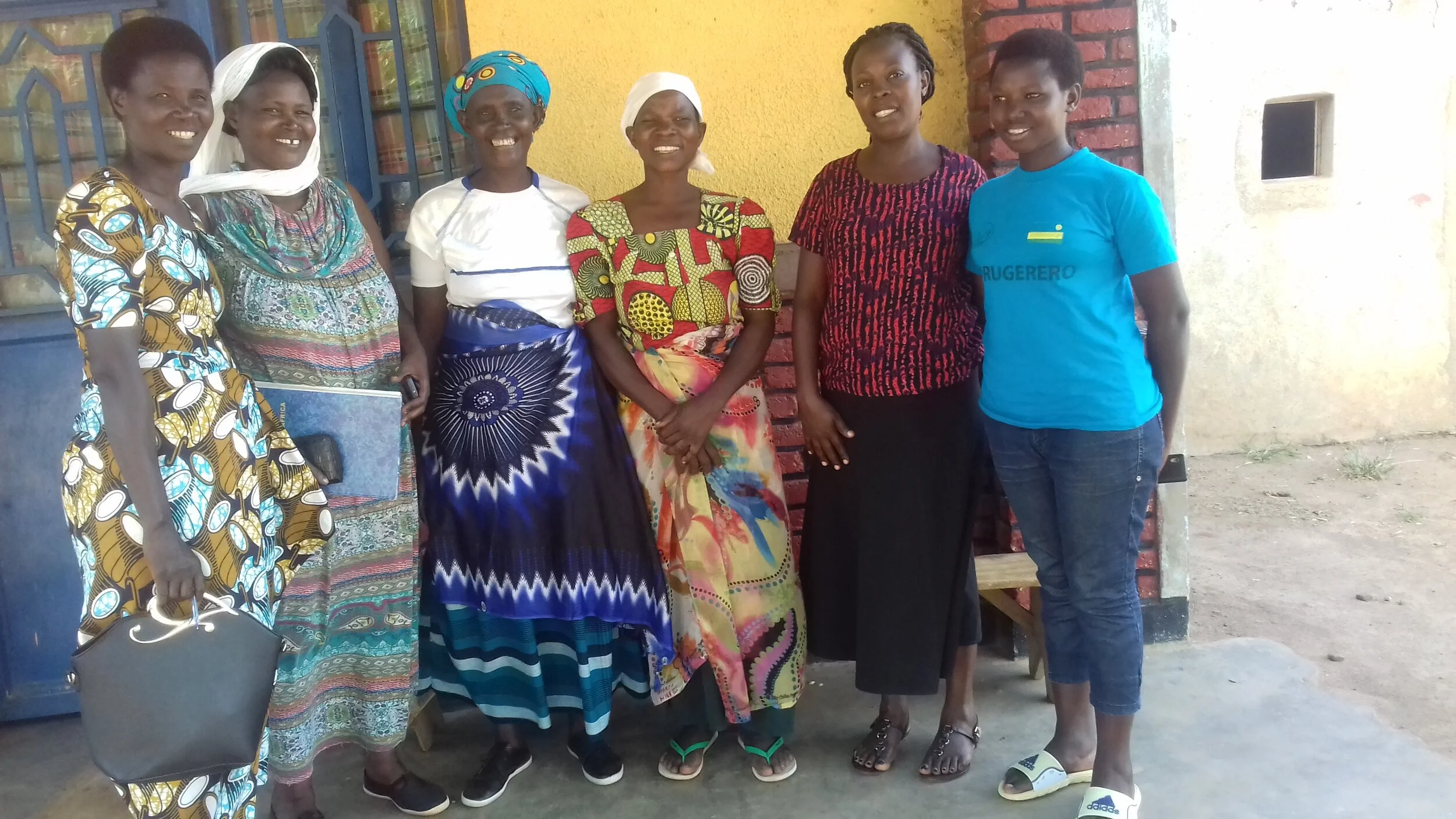 Veneranda with the sections of the Parent Guardian Cooperative and scholar Claudine