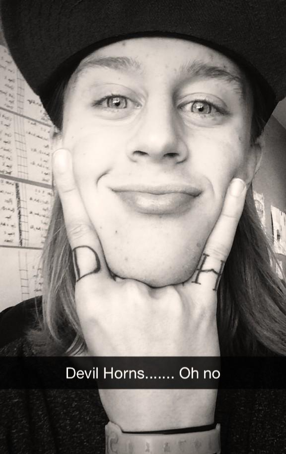 Wheeler making a “Devils horns” sign with his fingers.