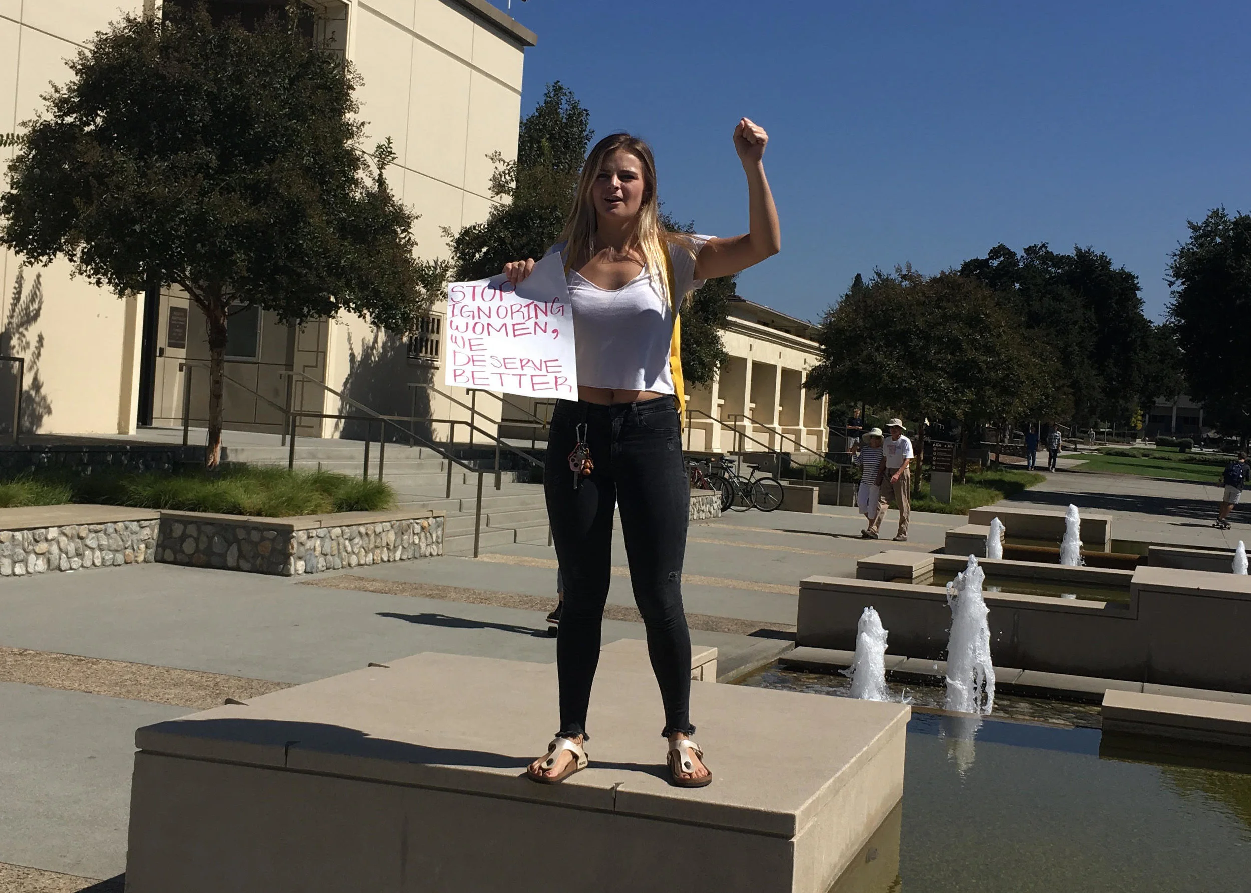 A protest organizer leads chants outside the Hub // Malea Martin for The Forum