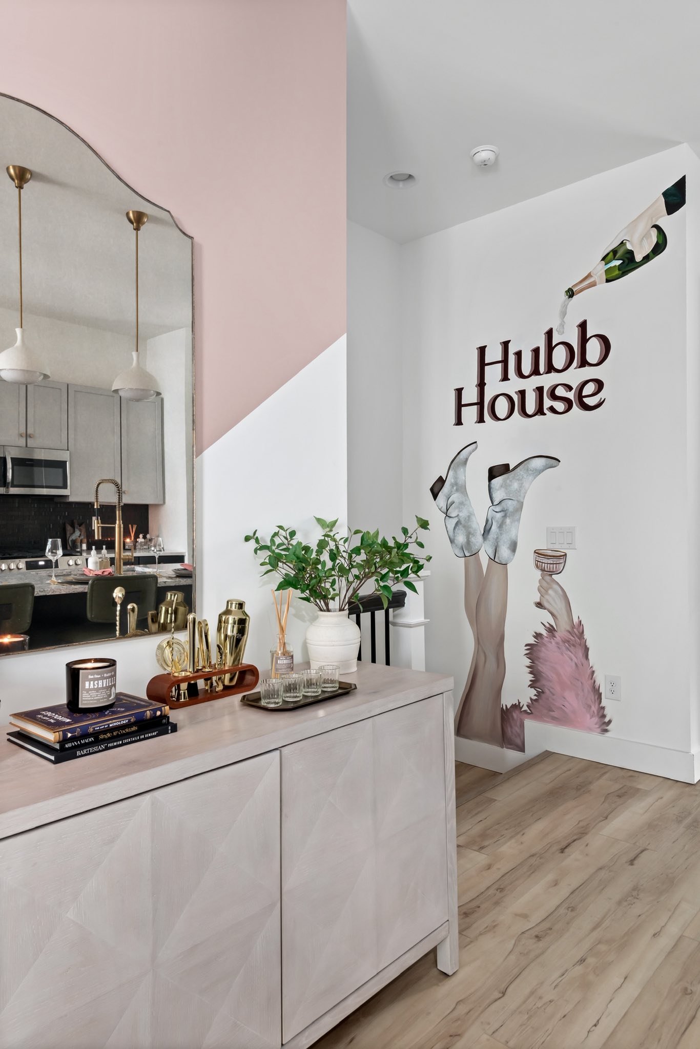 Interior Airbnb Wall mural.  "Hubb House" and a bottle pouring into her hand. Nashville Tennessee, Lindsay Hubbard Airbnb.
