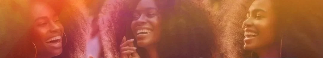 Three women smiling and laughing