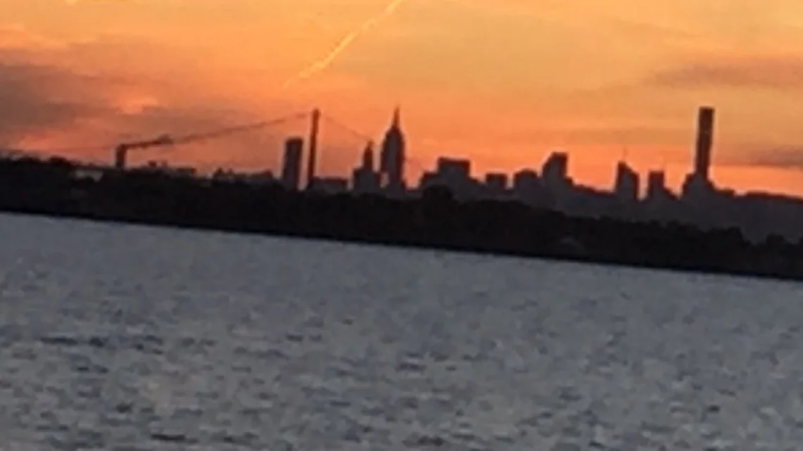New York City Sunset Cruise - Orange sky and black buildings