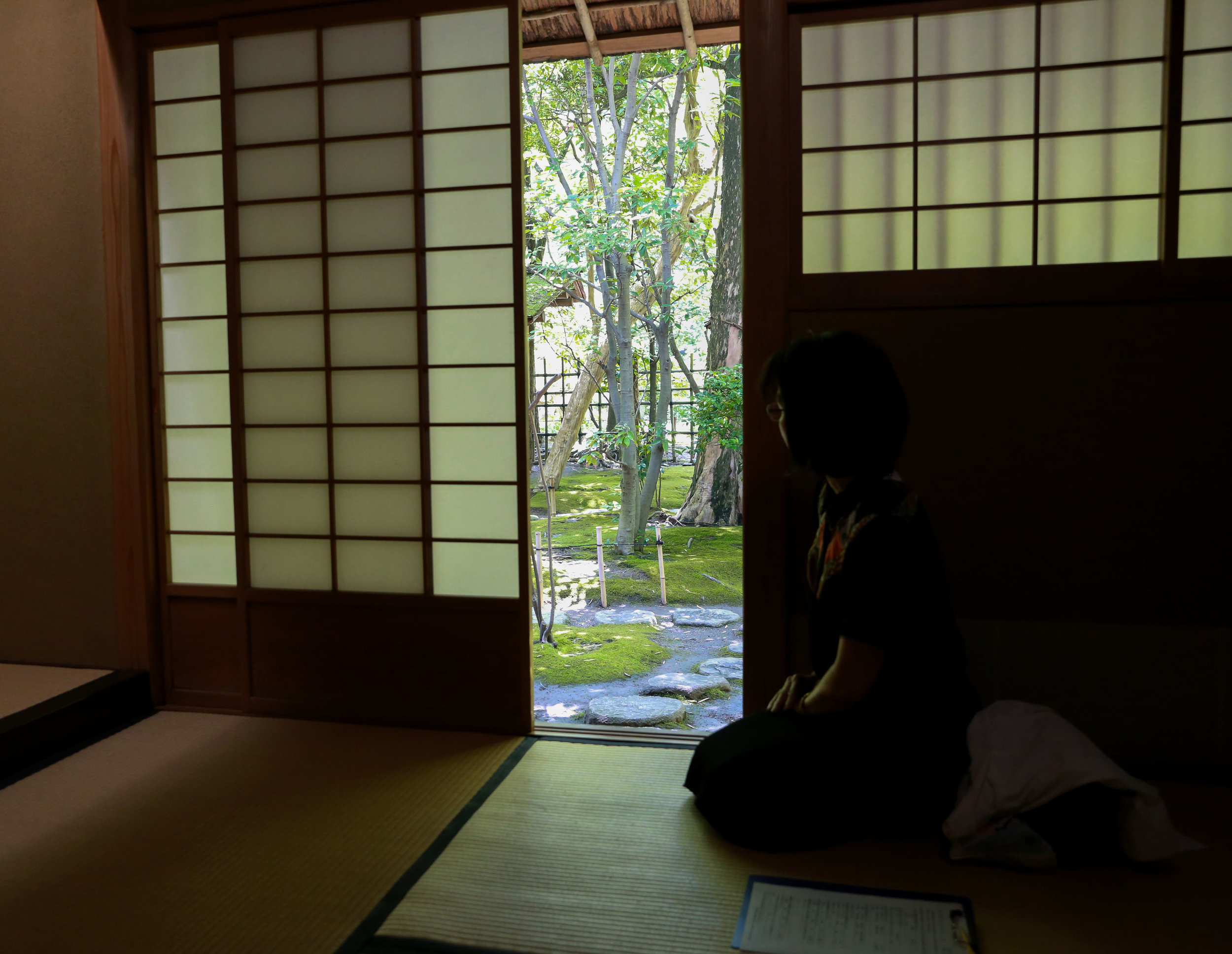  A woman enjoys the view outside the chashitsu at Rakusui-en in Fukuoka, Japan, June 22, 2018. 