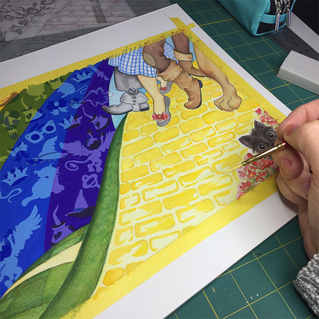 and here, working on the infamous yellow brick road. (which i eventually repainted between each brick so it was less visually loud. brought it all to yellow instead of a too-subtle mortar in-between bricks.) you can also see i tried to make the slippers silver here. boring. so i made them look sequin-y later. 