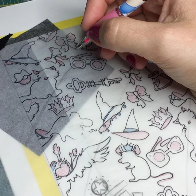 once the background drawing is complete, i put a bit of transfer paper between the drawing and my measured illustration board….