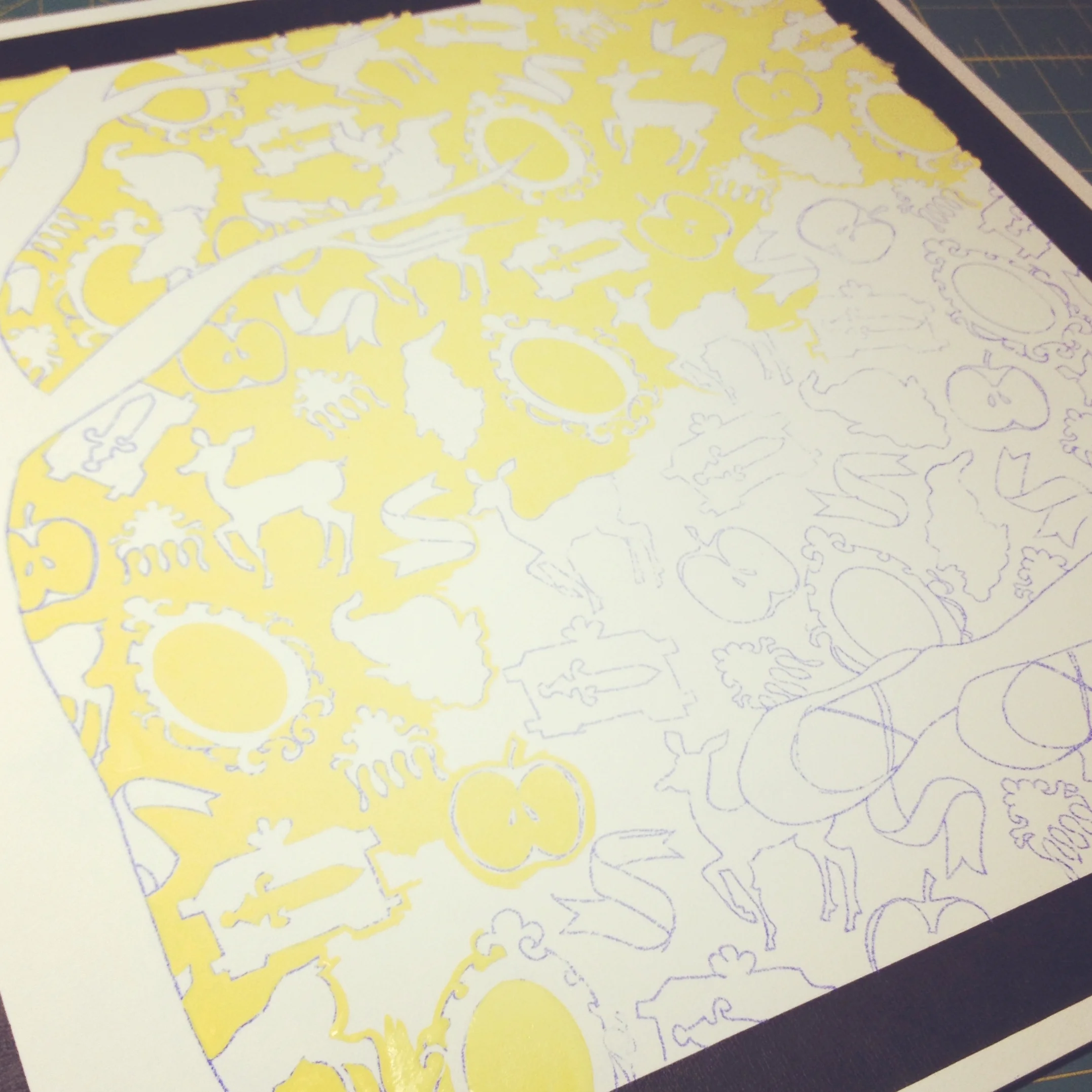 once the drawing and pattern are transferred to the board, i first paint in the background colour around each and every story icon in the background.