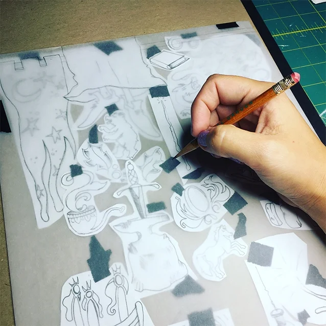 so when i finally had no more NEW notes or snippets of the story i’d missed, i compiled all of my icon drawings from my sketchbook and transferred them to a piece of tracing paper to make sure they all fit nice & snug how i pictured them in my head!