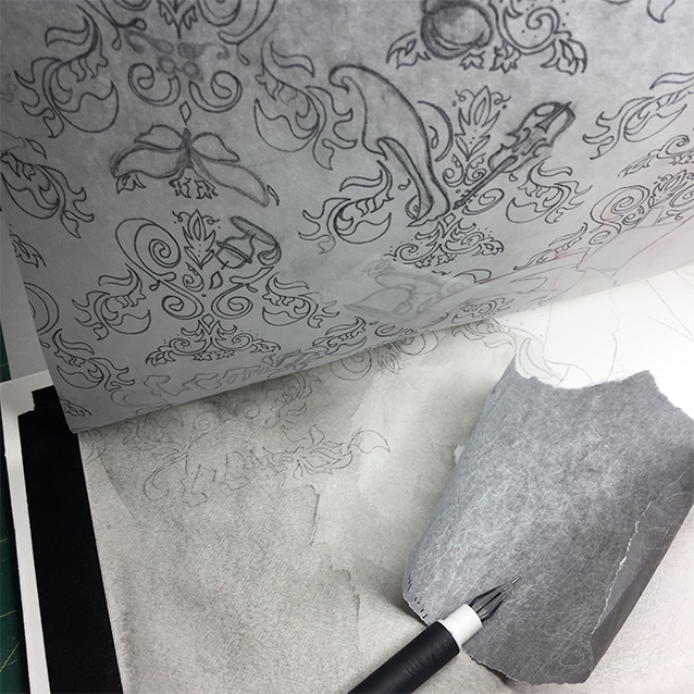 once i finalized my pattern and hidden-image drawing on tracing paper, i stained my illustration board with a light wash of india ink to give it that creepy foggy london effect. then i taped the drawing to the top of my board, and using transfer paper, re-traced the drawing to leave me a light grey line where i was to paint in the final image.