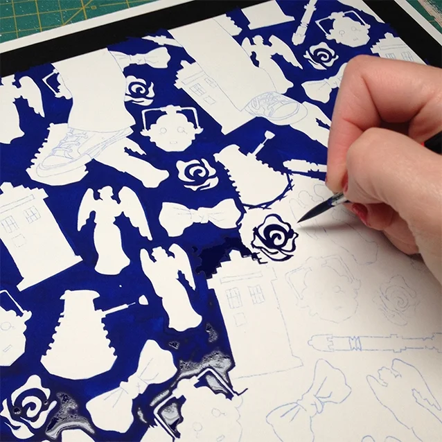 my right hand seen here painting in the blue background with beautiful gouache around each and every icon shape… this step has to be done in once sitting for our best chance of an even layer of gouache colour. it took about 6 (+?) hours.