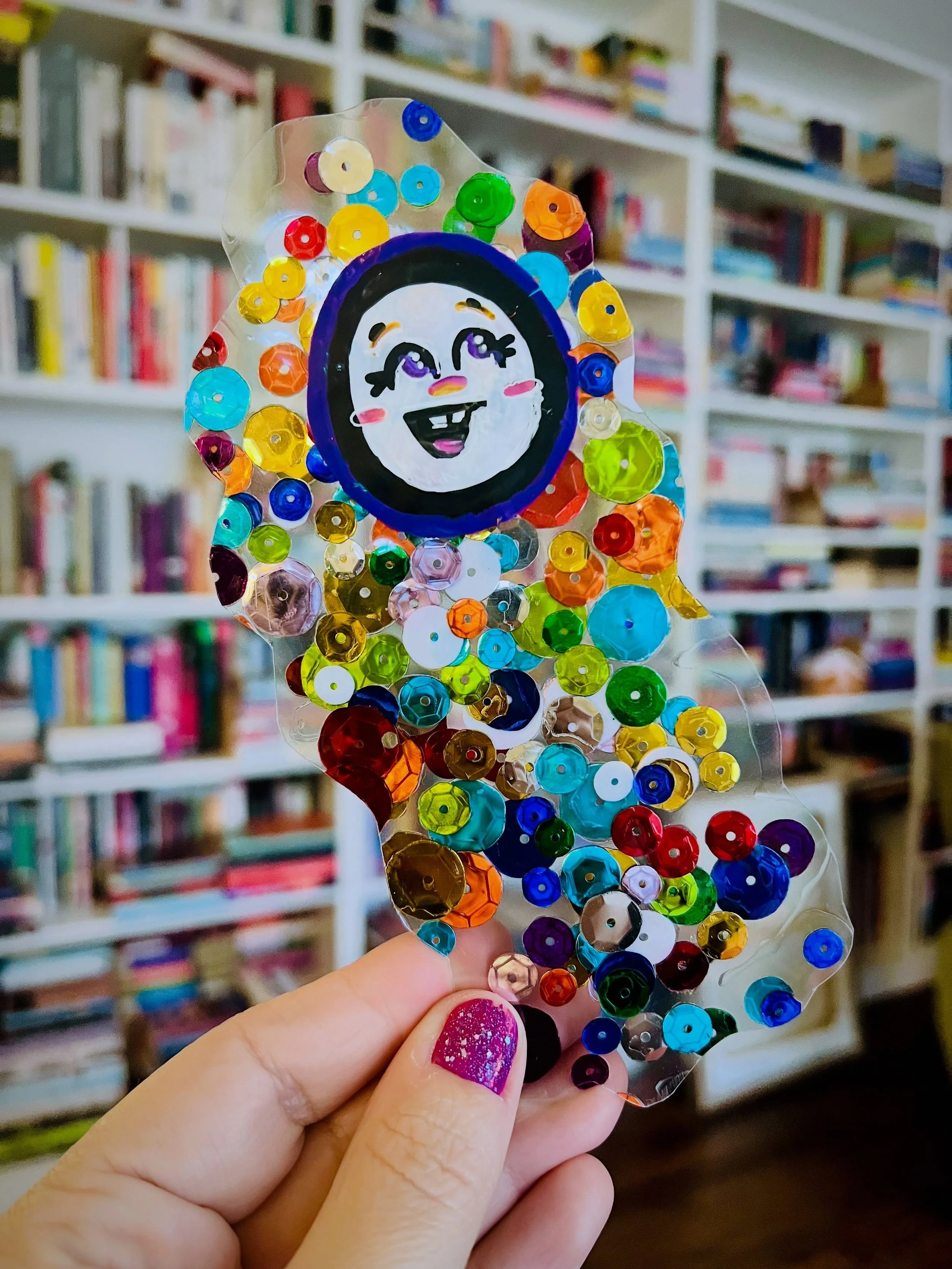 ✨👻 this is gertrude the ghost. she&rsquo;s dressed as a sequined confetti blob for halloween. 👻✨
📚
i made her at bookclub because of course i&rsquo;m friends with people who have home laminators. 
🤭
she&rsquo;s been an excellent bookmark so far t