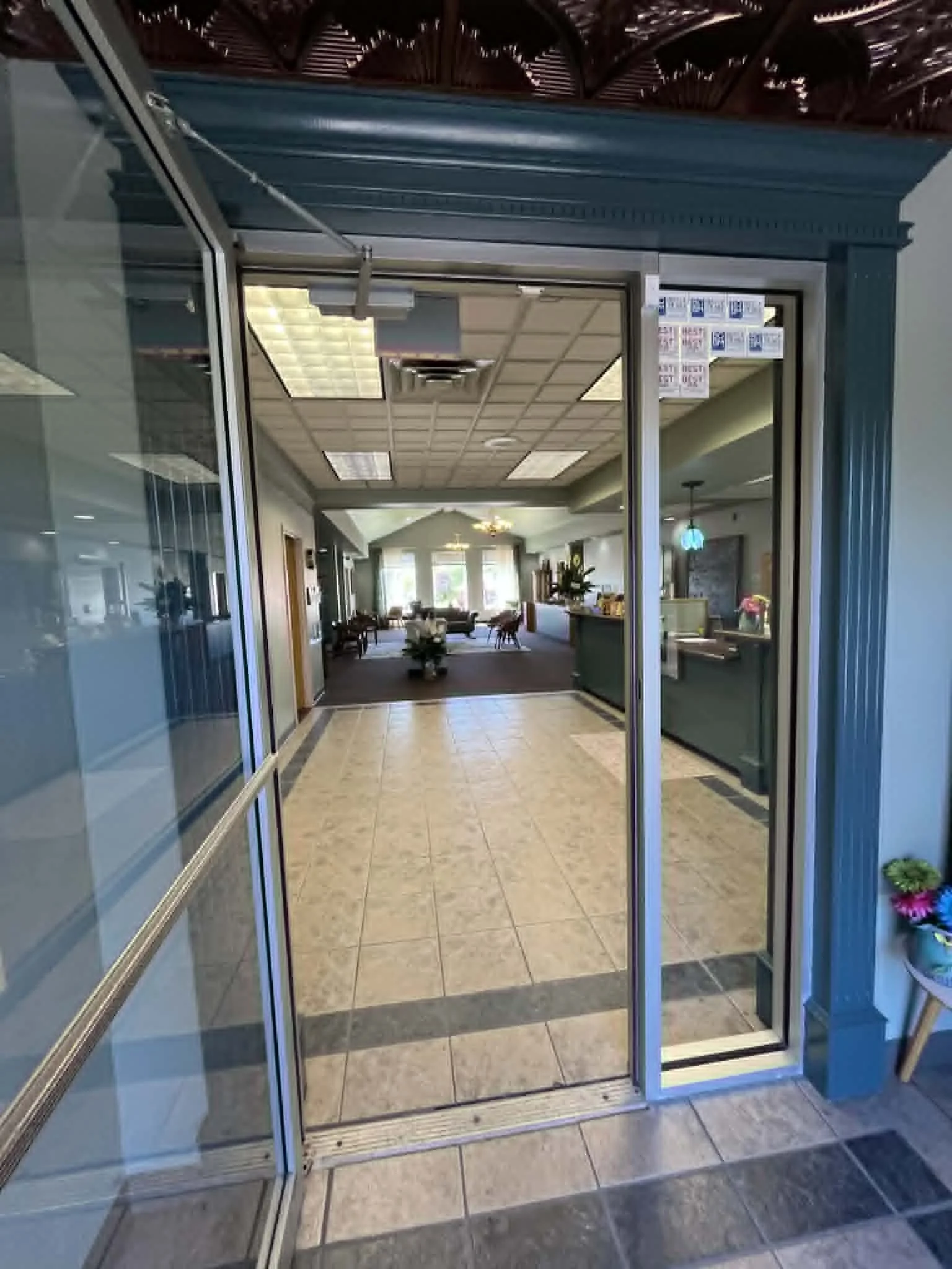 Entrance into lobby with check in counter and waiting room in view