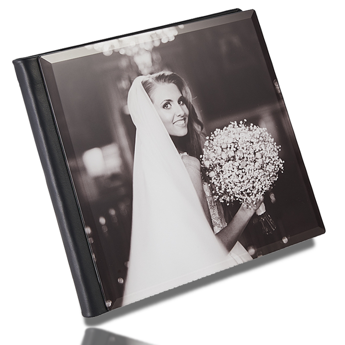 Lulan Studio heirloom wedding album standing upright, a black-and-white portrait of the bride set beneath its crystal-glass cover